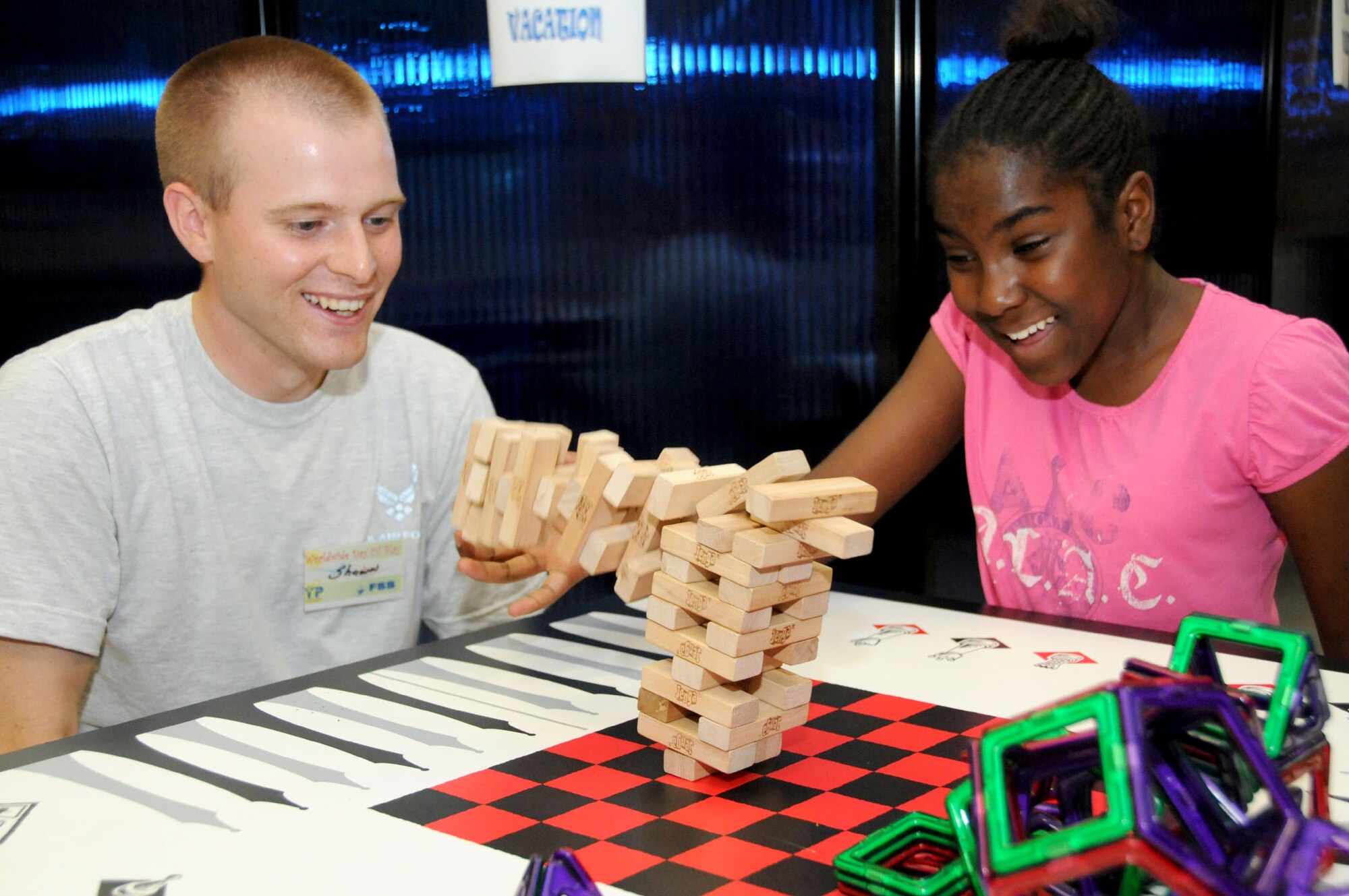 Airman 1st Class Shawn Milam, 366th Training Squadron Detachment 6 from the
Seabee Base inGulfport, watches as the Jenga blocks fall on Dezha Hutchins, daughter of Senior Airman Cedrick Hutchins, 81st Surgical Operations Squadron, and Staff Sgt. Makela Hutchins, 81st Medical Operations Squadron.  (U.S. Air Force photo by Kemberly Groue)