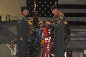 LANGLEY AIR FORCE BASE, Va -- Lt. Col. Joel Cook, 71st Fighter Squadron commander, furls the guidon, with Col. Richard H. Boutwell, 1st Operations Group commander, during the 71st Fighter Squadron inactivation ceremony Sept. 30. The inactivation is due to the Air Force's reduction in fighter aircraft in a cost-saving effort for modernization of our weapons systems. (U.S. Air Force photo/Staff Sgt. Ashley Hawkins)(RELEASED)