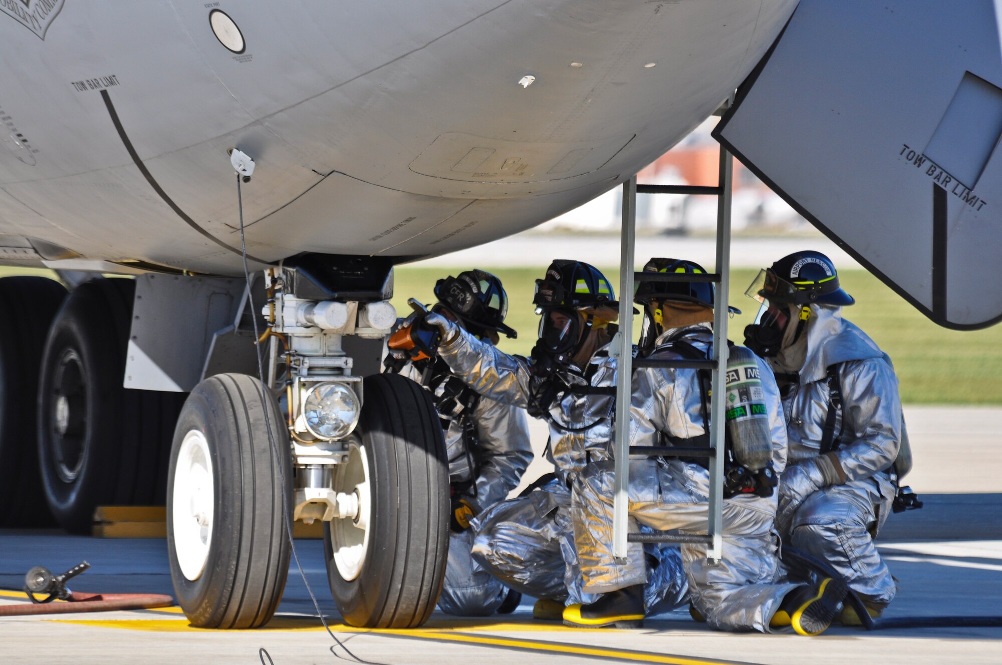 Members of the 128th Air Refueling Wing Fire Department, Milwaukee, WI respond to a preflight emergency of smoke in the cockpit of a KC-135 Stratotanker on September 30th, 2010. A member of the fire department points toward where the equipment malfunction occurred after conducting a residual heat signature scan with a thermal imaging device. The aircraft was returned to Maintenance without incident. Air Force photo by SSgt Jeremy Wilson (Released)