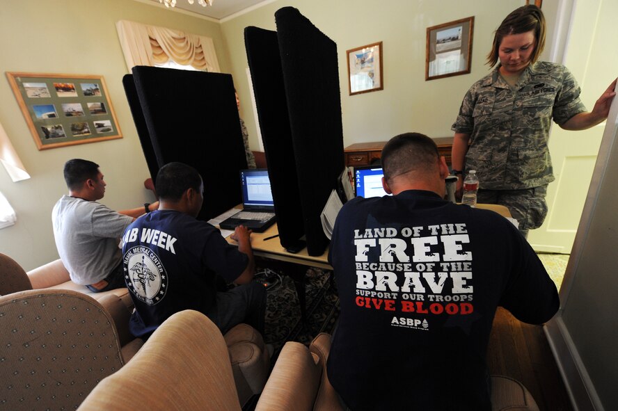 Staff Sgt. Heather Cozad, 4th Combat Camera Squadron photographer, registers to donate blood with the help of personnel from Naval Medical Center San Diego, at March Air Reserve Base Blood Drive, Sept. 18, 2010. (U.S. Air Force photo by Tech. Sgt. Christine Jones)