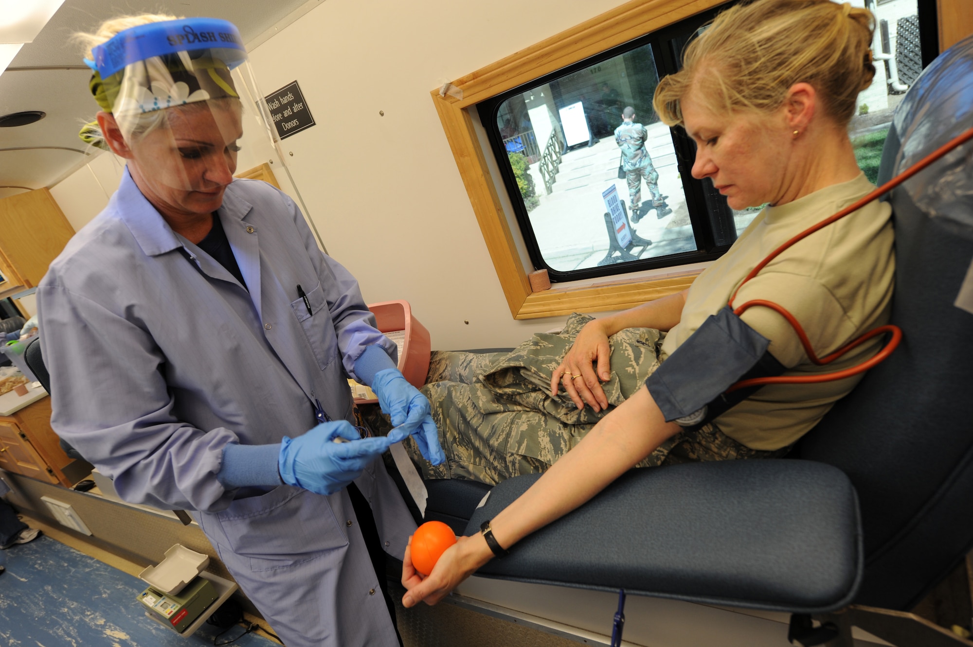 Col. Mary Lussier, 752nd Medical Squadron commander, donates blood at the March Air Reserve Base Blood Drive Sept. 18. Assisting her is Guiliana Nachkova, a phlebotomist from Naval Medical Center San Diego. (U.S. Air Force photo by Tech. Sgt. Christine Jones)