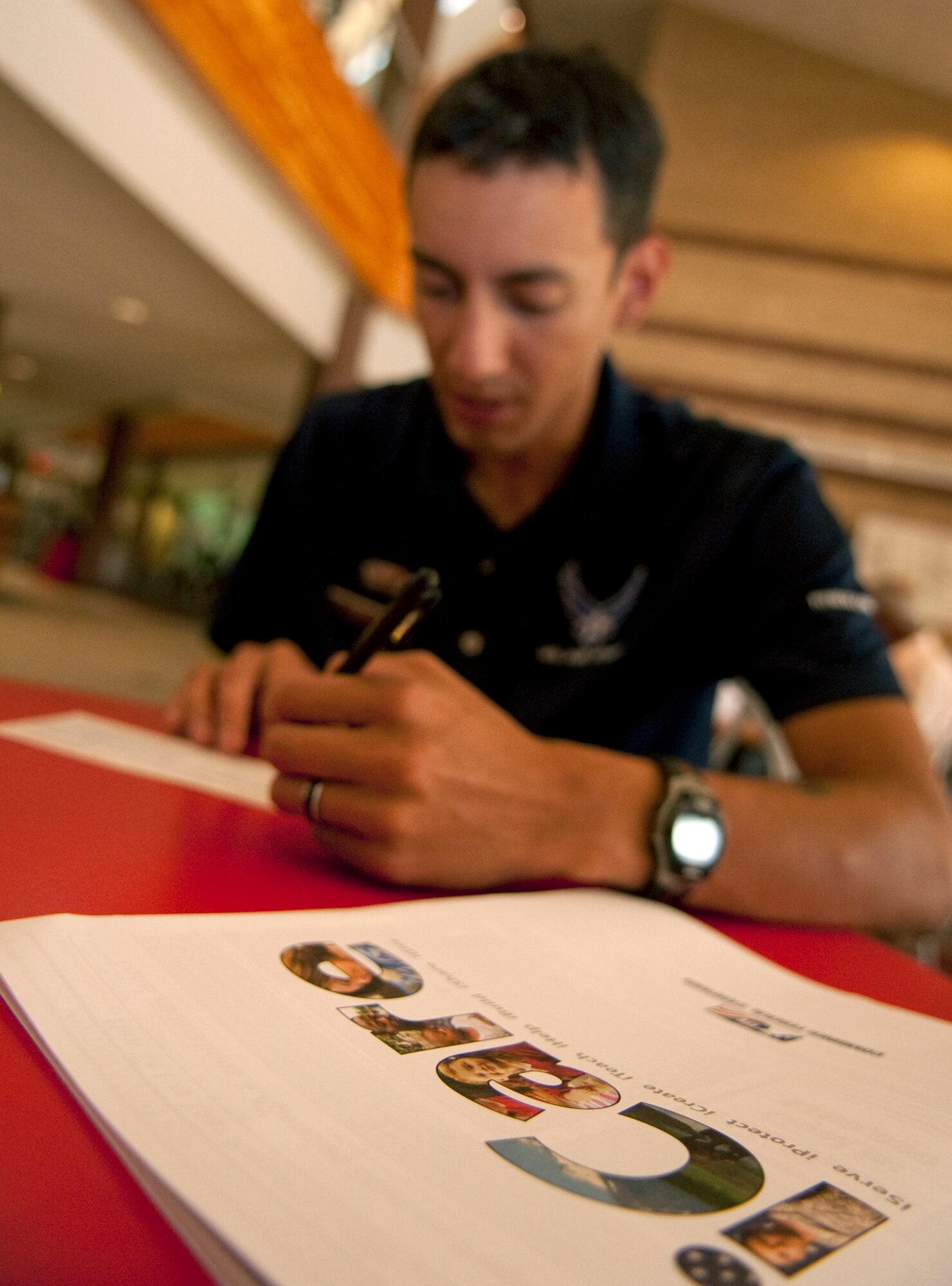 HOLLOMAN AIR FORCE BASE, N.M. -- Senior Airman David Escutia-Lopez, 49th Force Support Squadron, signs a Combined Federal Campaign pledge card during the CFC Kick Off Event at the Domenici Fitness and Sports Center Sept. 24, 2010. According to their official Web site, the CFC is the world's largest and most successful annual workplace charity campaign that helps raise millions of dollars each year for non-profit organizations providing health and human service benefits throughout the world. This year's CFC goal is higher than ever before at $100,000. Members of Team Holloman can make a pledge by contacting their unit CFC point of contact, or by contacting Holloman's main CFC point of contact, Master Sgt. Jamie Schuster at 575-572-3151. (U.S. Air Force photo by Senior Airman Sondra Escutia / Released)