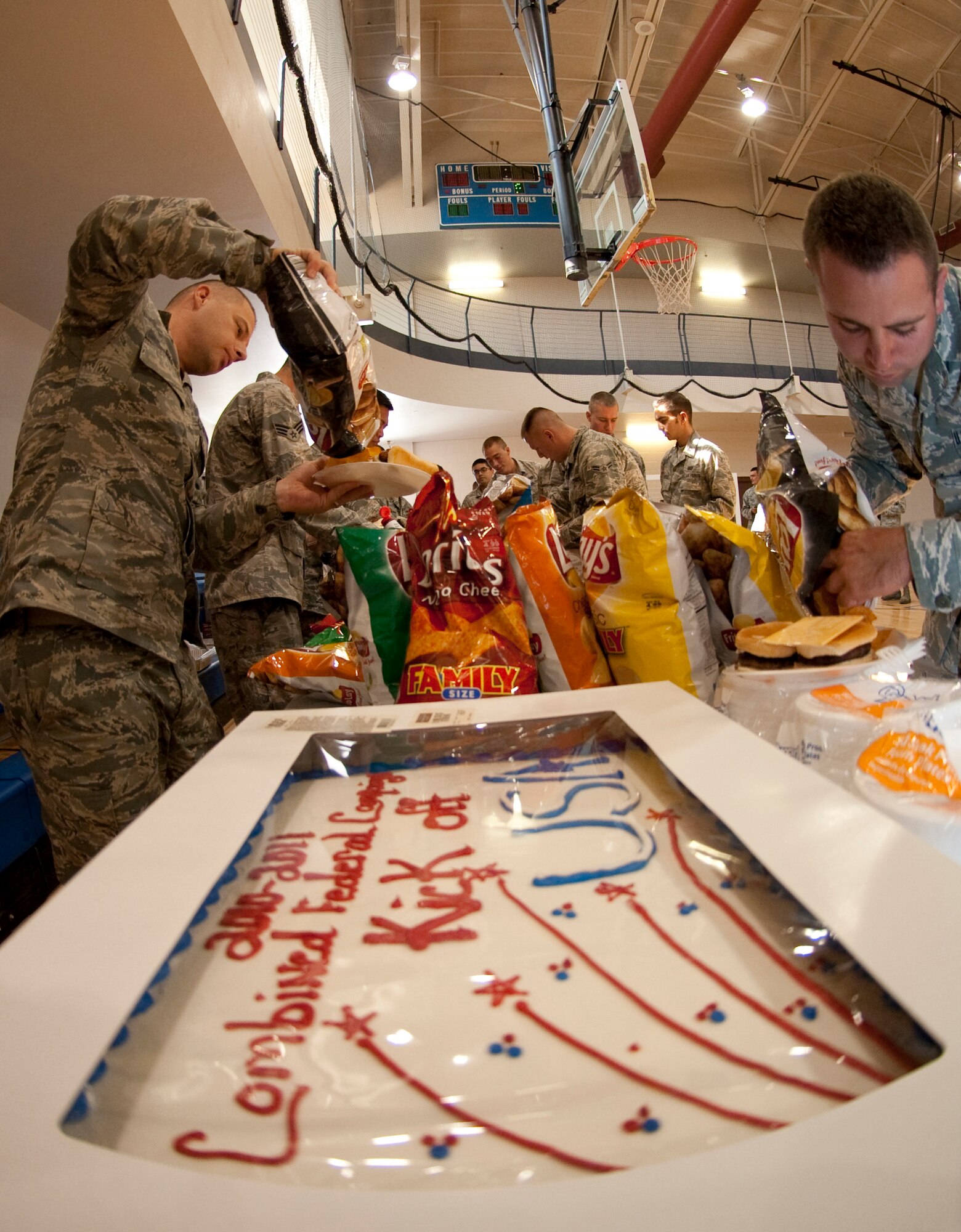 HOLLOMAN AIR FORCE BASE, N.M. -- Members of Team Holloman enjoy a free meal and cake during the annual Combined Federal Campaign Kick Off at the Domenici Fitness and Sports Center Sept. 24, 2010. The Kick Off event allowed Team Holloman members to hear what the CFC is all about and give them a chance to donate, while also enjoying a free meal. Many local non-profit organizations also showcased their missions during the event through presentation booths. This year, there are more than 3,000 organizations that members can sign up to donate to. (U.S. Air Force photo by Senior Airman Sondra Escutia / Released)