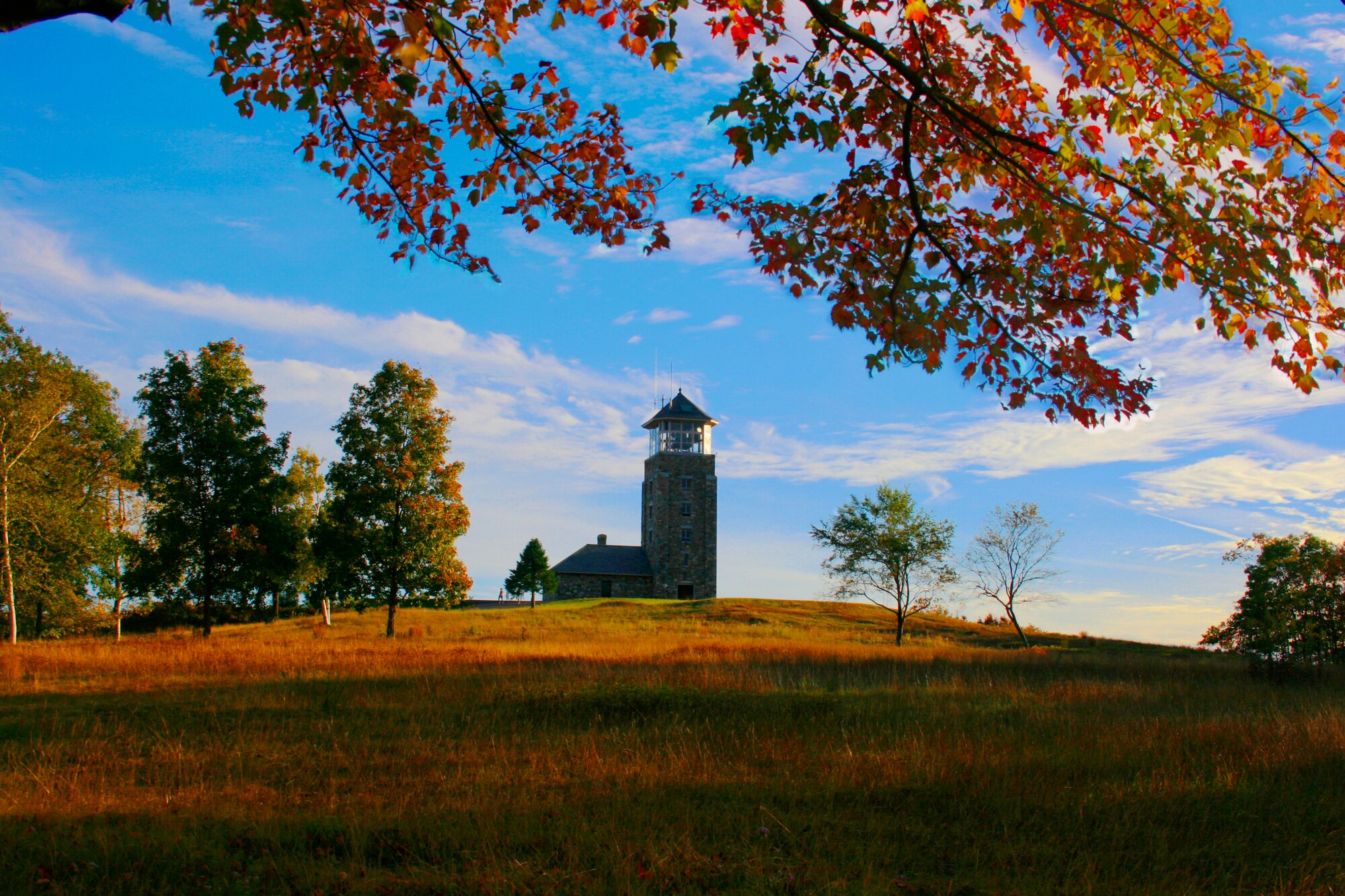 The Quabbin Tower sits atop Quabbin Hill, overlooking the 56,000 acres of the reservoir below.  Scenic hiking trails and paved bike paths abound in Quabbin Park, located at the southern end of the reservoir, affording many opportunities to stay fit and enjoy the New England fall folliage.  (Photo Illustration by Tech. Sgt. Timm Huffman)