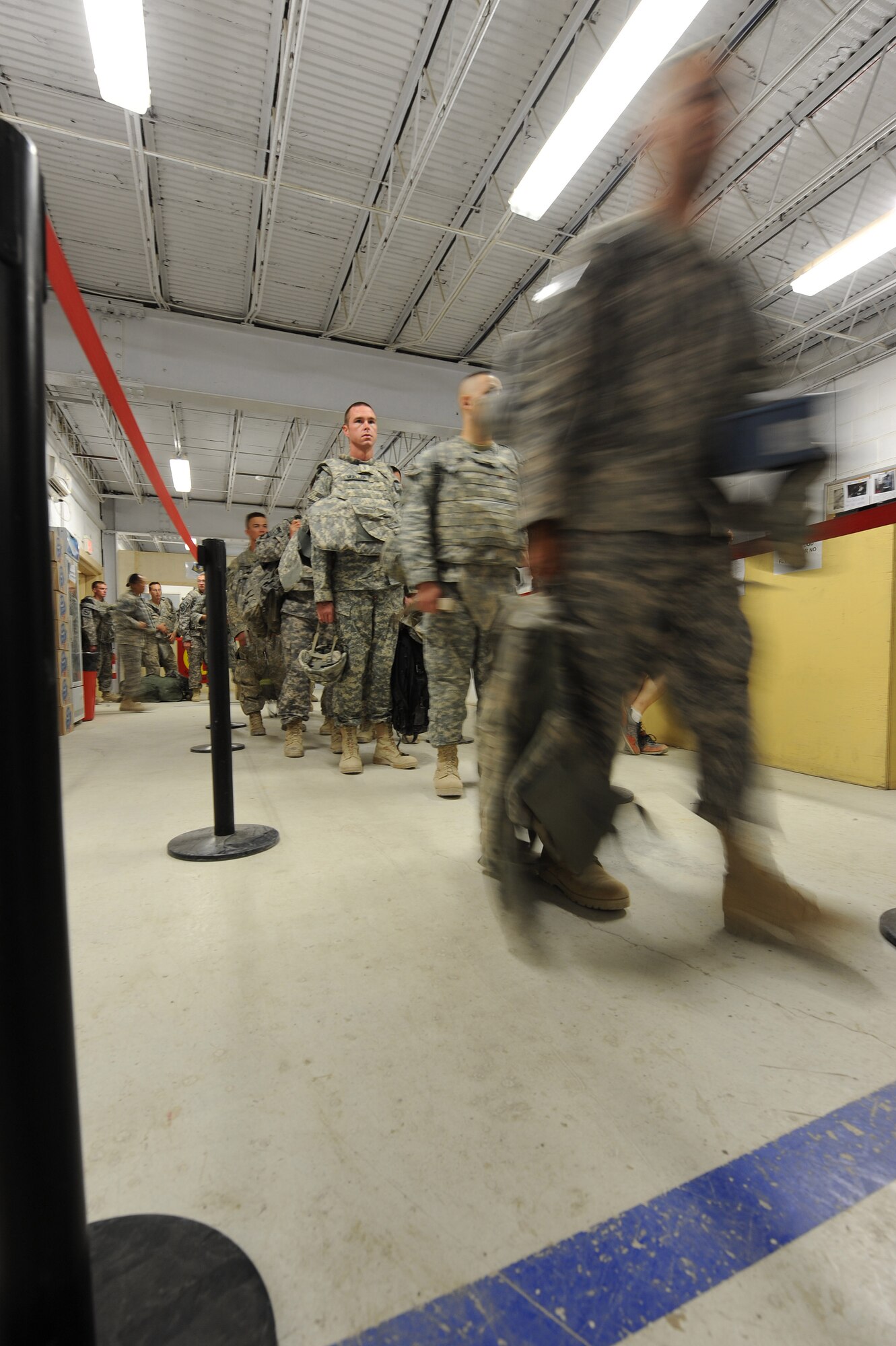 Soldiers deployed throughout Afghanistan enter the outbound passenger terminal Sept. 29, 2010, at Kandahar Airfield, Afghanistan.  The 451st Aerial Port Flight processed more than 16,000 passengers in September. (U.S. Air Force photo by Tech. Sgt. Chad Chisholm/Released)