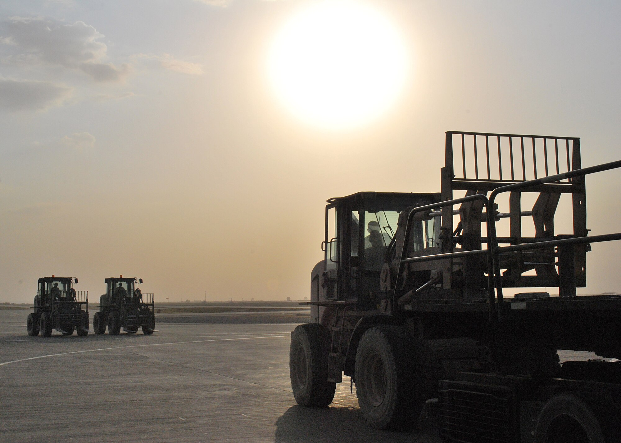 Airmen from the 451st Aerial Port Flight line up in forklifts for an engine-running offload of a C-17 Globemaster III Sept. 30, 2010, at Kandahar Airfield, Afghanistan. The 451st APF handled more than 26 million pounds of cargo in the month of September. (U.S. Air Force photo by Senior Airman Melissa B. White/Released)
