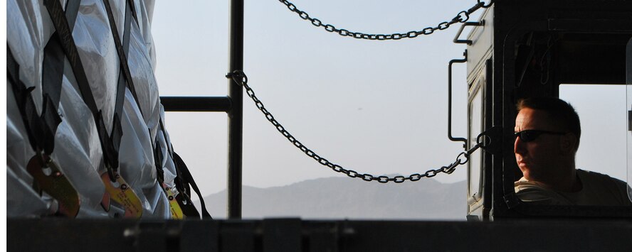 Tech. Sgt. Edward Taylor helps unload cargo from a C-17 Globemaster III during an engine-running offload Sept. 29, 2010, at Kandahar Airfield, Afghanistan. Sergeant Taylor is a ramp crew chief with the 451st Aerial Port Flight and is deployed from Pope Air Force Base, N.C. (U.S. Air Force Photo/Senior Airman Melissa B. White) 