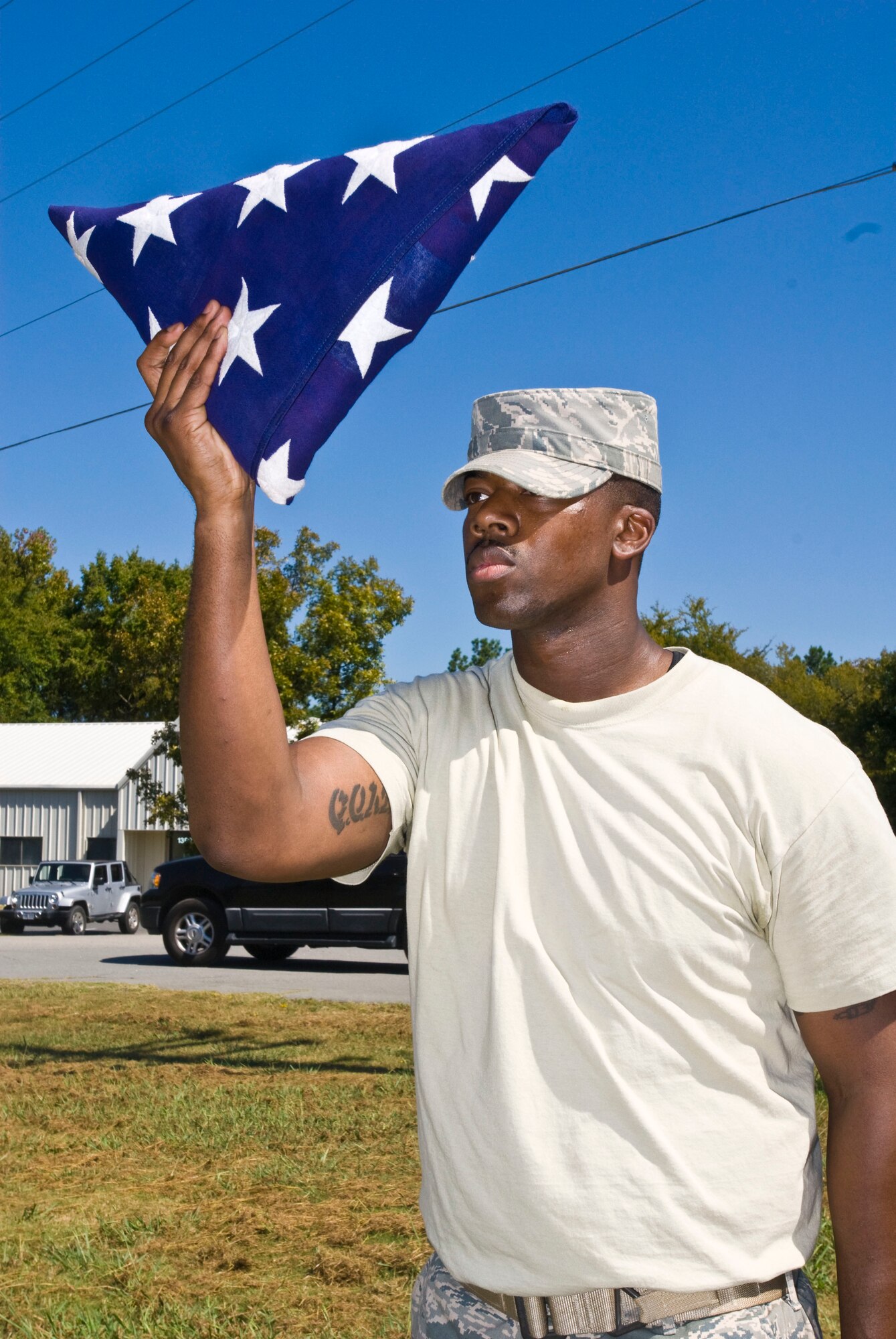 Staff Sgt. Chalk Mitchell, 189th Security Forces Squadron, holds up a folded internment flag during a pre-test evaluation here Sept. 28. Base honor guard members support various ceremonies across Arkansas including two counties in Tennessee. (U.S. Air Force photo by Staff Sgt. Nestor Cruz)