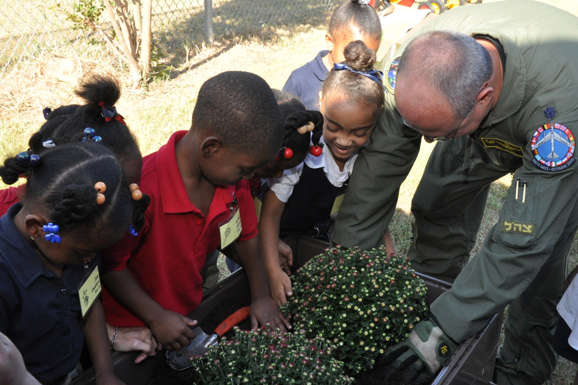 Lt. Col. David Webb, commander of the 917th Operations Support Flight, at Barksdale Air Force Base, La., plants a flowering bush for a group of Pre-K students at Westwood Elementary School in Shreveport, La., Sept. 28, 2010. Westwood Pre-K teacher, Mrs. Valli Webb planned the planting project to allow her students the opportunity to see the growth of their efforts.  Through the year, plans are to replace the flowers with seasonal plants and vegetables to be a continuing lesson for the students that could last a lifetime. Westwood Elementary supports children from Pre-K through 5th Grade. (U.S. Air Force photo/Tech. Sgt. Jeff Walston)

