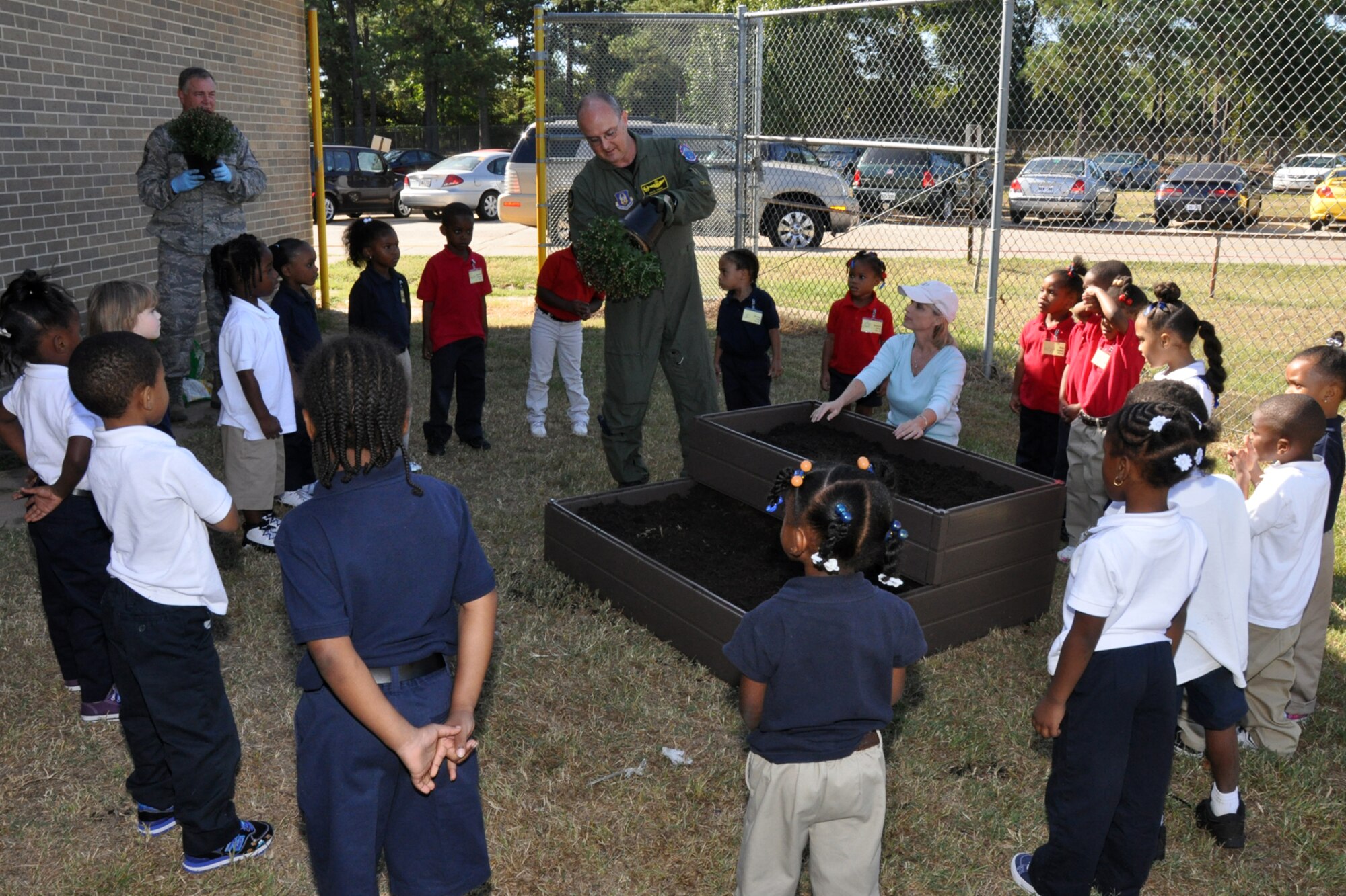 Lt. Col. David Webb, commander of the 917th Operations Support Flight demonstrates the proper preparation of a potted plant for a group of Pre-K students at Westwood Elementary School in Shreveport, La., Sept. 28, 2010. Westwood Pre-K teacher, Mrs. Valli Webb planned the planting project to allow her students the opportunity to see the growth of their efforts. Through the year, plans are to replace the flowers with seasonal plants and vegetables to be a continuing lesson for the students that could last a lifetime. Westwood Elementary supports children from Pre-K through 5th Grade. (U.S. Air Force photo/Tech. Sgt. Jeff Walston)