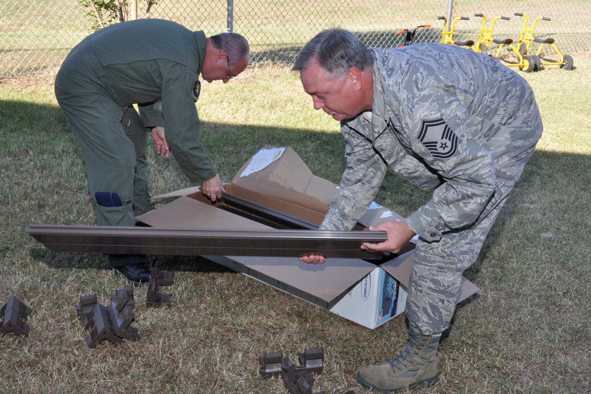 Lt. Col. David Webb, commander of the 917th Operations Support Flight, and Senior Master Sgt. J. Womack, aircrew flight equipment superintendent for the 917th OSF, at Barksdale Air Force Base, La., breakout a portable flower bed they are installing at Westwood Elementary School in Shreveport, La., Sept. 28, 2010. Westwood Pre-K teacher, Mrs. Valli Webb planned the planting project to allow her students the opportunity to see the growth of their efforts. Through the year, plans are to replace the flowers with seasonal plants and vegetables to be a continuing lesson for the students that could last a lifetime. Westwood Elementary supports children from Pre-K through 5th Grade. (U.S. Air Force photo/Tech. Sgt. Jeff Walston)