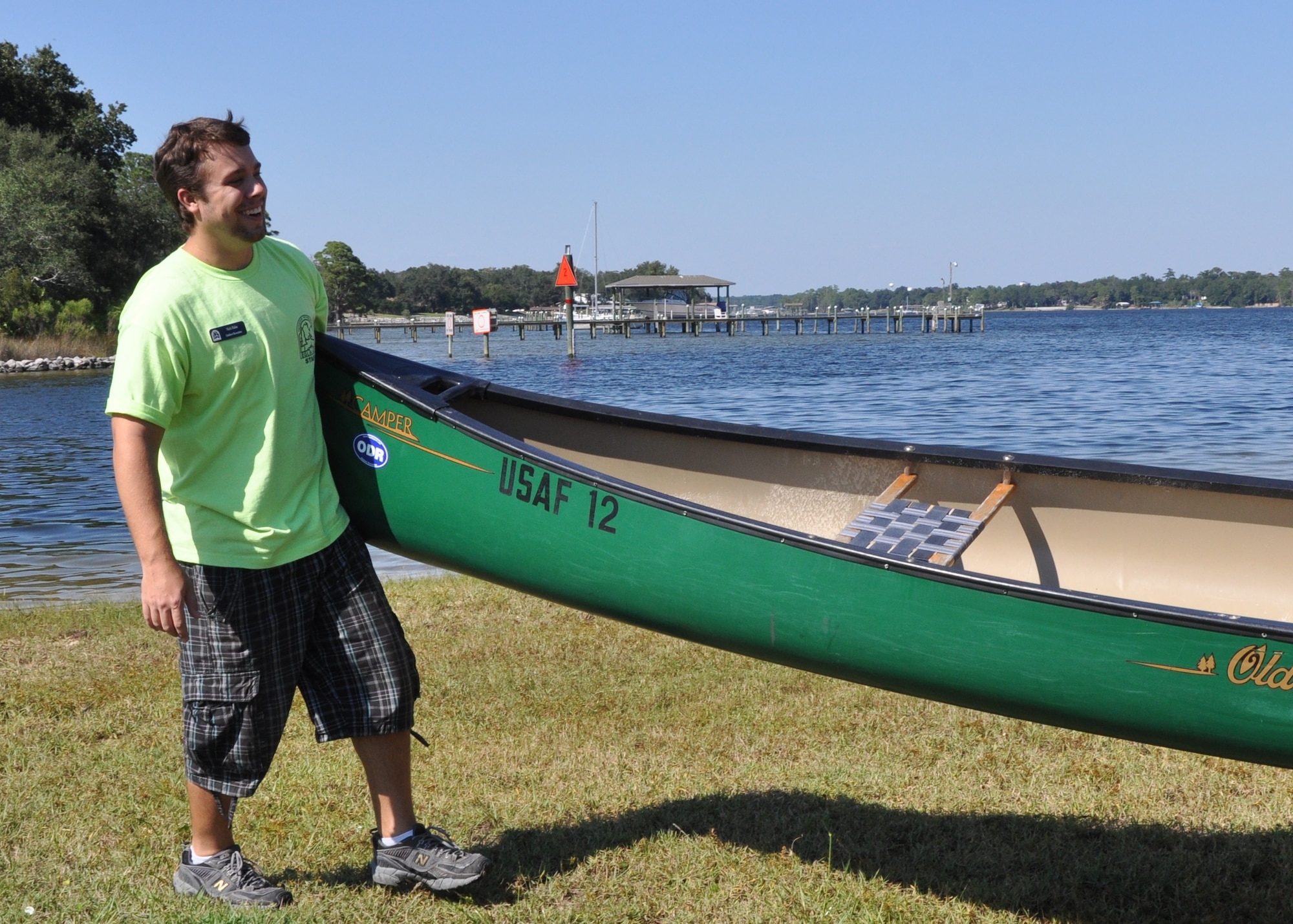 Nick Halas, recreation assistant, helps carry a canoe back to its resting place at Eglin’s Outdoor Recreation dock Sept. 29. The facility recently started moonlight paddle tours as something new to offer customers this fall. (U.S. Air Force photo/Chrissy Cuttita)