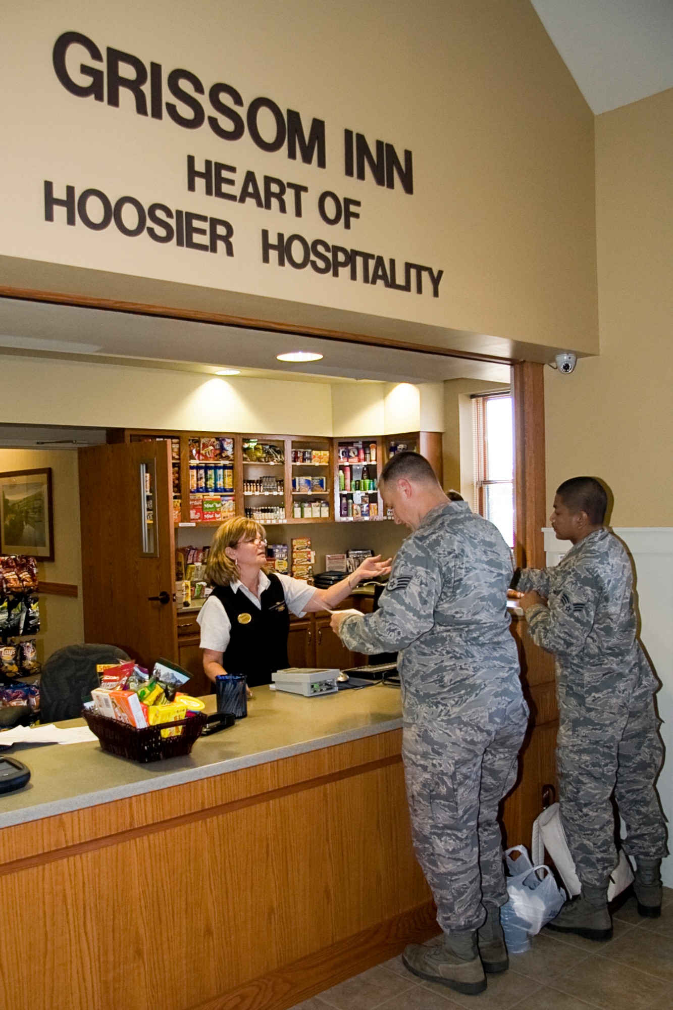 GRISSOM AIR RESERVE BASE, Ind. -- Customer service is just one of the many things to elevate the Grissom Inn to the top of Air Force Inns, and Ritta Baker exhibits that as she helps check out two guests here Sept. 29. Each Air Force Inn undergoes a yearly certification process which requires a score of 85 percent to pass. The Grissom Inn earned a high grade of 94.5 percent, which puts the on-base lodging facility at the top of Air Force Inns. This is the first time the Grissom Inn has scored this high on the certification, which is due in part to the many changes that have taken place at the facility recently. Mrs. Baker is a guest services manager at the Grissom Inn. (U.S. Air Force photo/Tech. Sgt. Mark R. W. Orders-Woempner)
