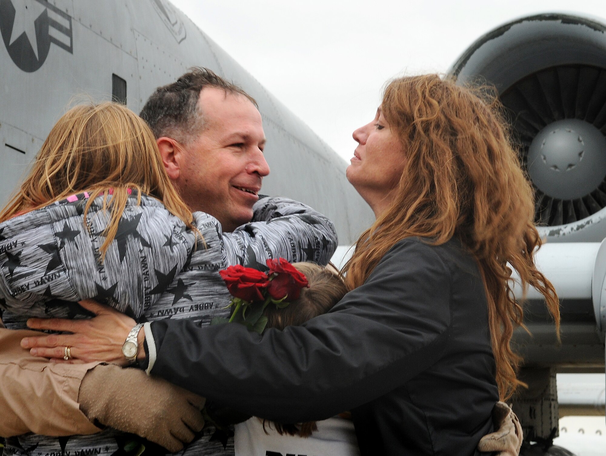 SPANGDAHLEM AIR BASE, Germany – Lt. Col. Douglas Sirk, 81st Fighter Squadron assistant director of operations, hugs his wife and kids Sept. 27 after returning from a five-month deployment to Kandahar, Afghanistan. Colonel Sirk was one of five A-10 Thunderbolt II pilots to return on that day. (U.S. Air Force photo/Staff Sgt. Benjamin Wilson)