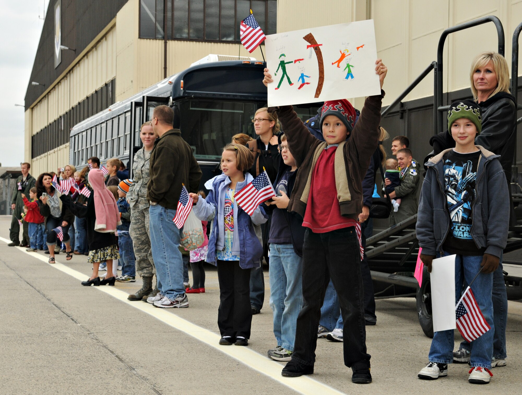 SPANGDAHLEM AIR BASE, Germany – The family and friends of five returning A-10 Thunderbolt II pilots from the 81st Fighter Squadron hold signs and wave flags on the flightline Sept. 27. The A-10s returned to Spangdahlem Air Base after a five-month deployment to Kandahar, Afghanistan. (U.S. Air Force photo/Staff Sgt. Benjamin Wilson)
