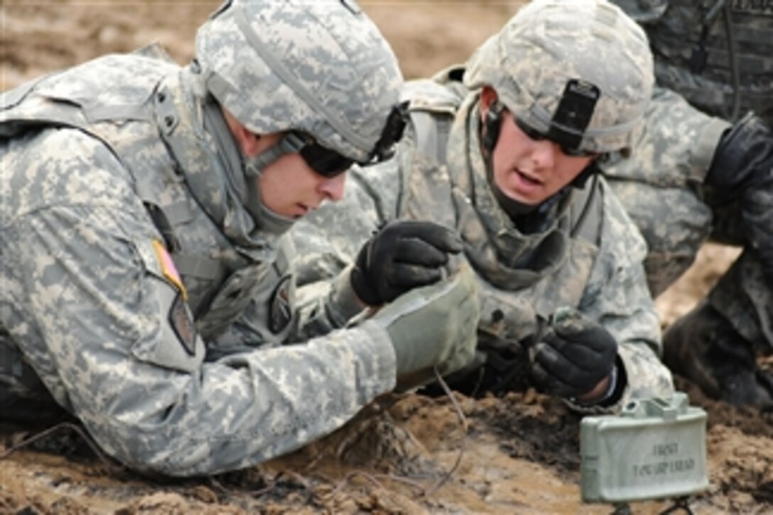 U.S. Army soldiers assigned to the 18th Combat Sustainment Support Battalion set up an M18A1 claymore anti-personnel mine during live-fire training at Grafenwoehr Training Area in Germany on Sept. 29, 2010.  