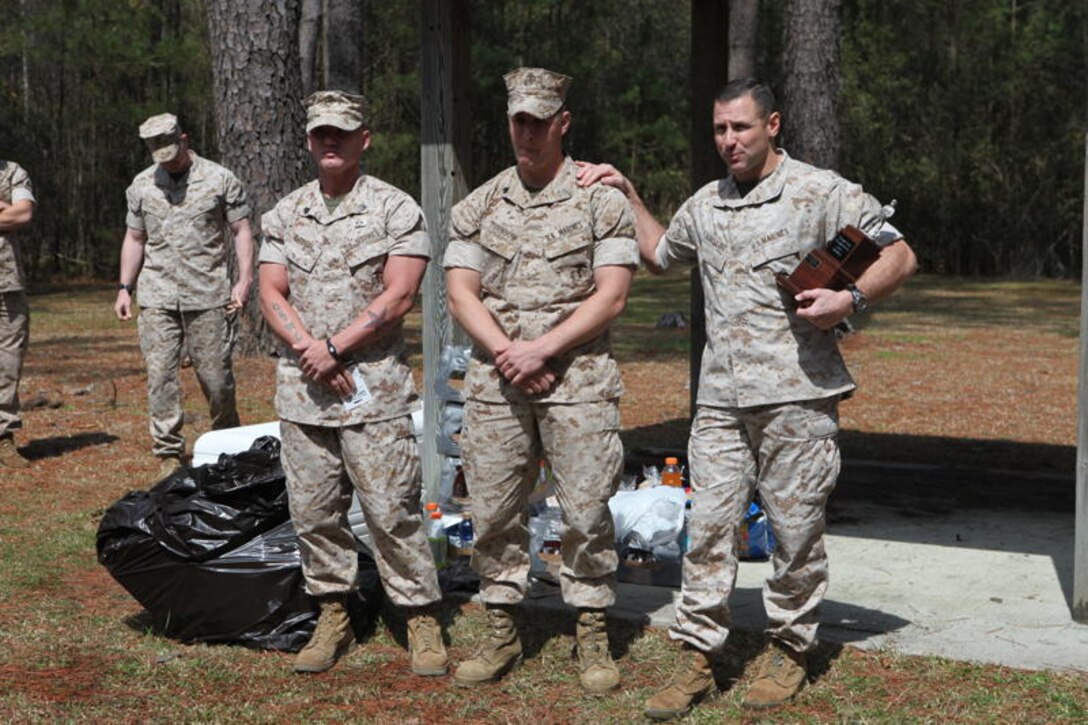 Lt. Col. John Armellino, commanding officer of AITB-East, stands with the winners of the Tough Man Competition, Sgt. Phillip Bateman and Sgt. Keith Turnbow, instructors with the Infantry Assaultman Leaders Course, School of Infantry- East, April 1. The competition was held to bring permanent personnel together in a friendly competition.