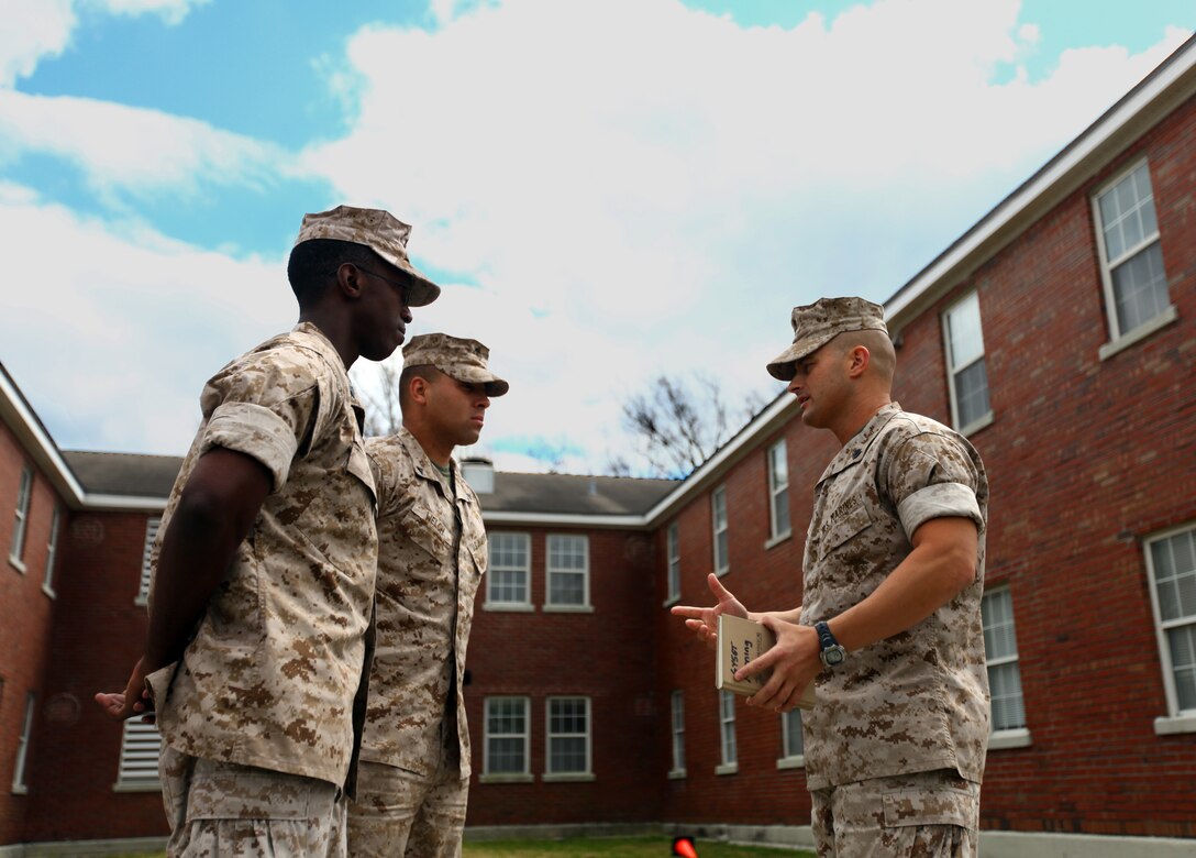 Gunnery Sergeant Daniel C. Morning, the Company Gunnery Sergeant for Headquarters and Service Company, Headquarters Battalion, 2nd Marine Division, talks with Marines within his company aboard Marine Corps Base Camp Lejeune, N.C., April 01, 2011. Morning is responsible for 27 different work sections and the welfare of more than 900 Marines and sailors.