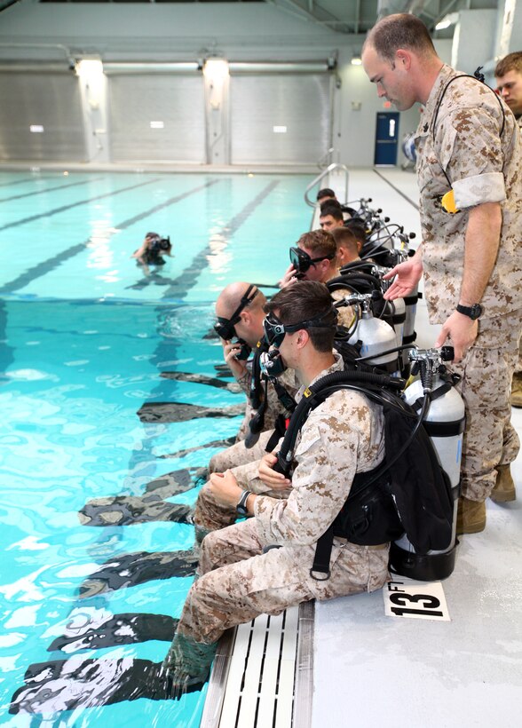 Marines from 2nd Reconnaissance Battalion, 2nd Marine Division; Force Reconnaissance Company, 2nd Marine Expeditionary Force and Marine Special Operations Command, prepare to dive into the water during the Dive Supervisor Course aboard Marine Corps Base Camp Lejeune, N.C., April 1, 2011. The purpose of the exercise was to train leaders within the organizations to be exceptional underwater combat divers.