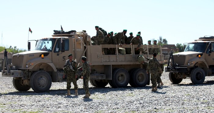 Soldiers with the 5th Kandak, Afghan National Army unload supplies at Forward Operating Base Jackson, Afghanistan.  Marines with Combat Logistics Battalion 8, 2nd Marine Logistics Group (Forward) escort the ANA to and from FOBs throughout Helmand Province, Afghanistan, for routine resupply missions. Usually they only resupply the other kandaks operating in the area, but April 29, 2011, the 5th Kandak transported food for Marines at Forward Operating Base Nolay, Afghanistan.