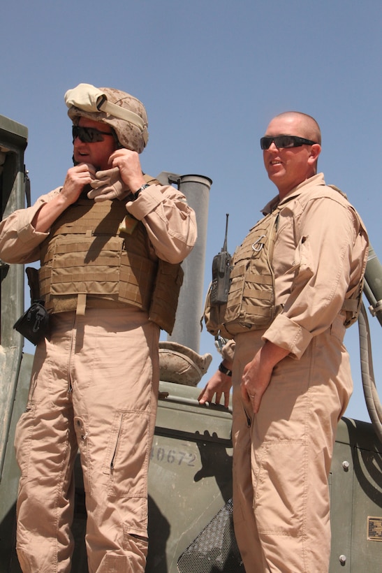 Brig. Gen. Glenn M. Walters, the 2nd Marine Aircraft Wing (Forward) commanding general speaks with Staff Sgt. Matthew L. Norman, an engineer equipment operator with Marine Wing Support Squadron 272 about the operation of a bulldozer on Camp Bastion, Afghanistan, April 1. Walters and Sgt. Maj. Henry A. Prutch, the 2nd MAW (Fwd.) sergeant major, visited with MWSS-272 Marines preparing living spaces for 2nd MAW (Fwd.) Marines at Camp Bastion’s hangars.