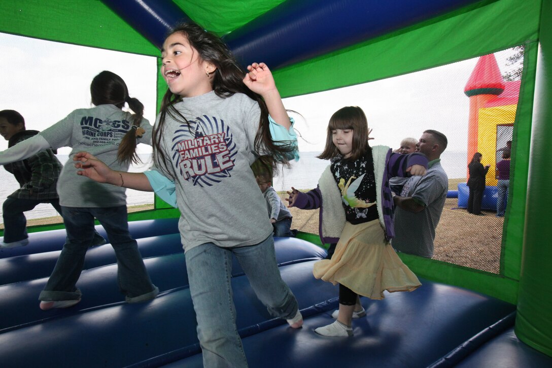 Mya Brown, 9, runs around the bounce house outside of Miller’s Landing during the “Wee Play” event April 1. Games for the children included everything from bounce houses to cupcake decorating. According to Brenda Mitchell, the new parent support program manager, the event was set up to, “honor the littlest children in our military community.”