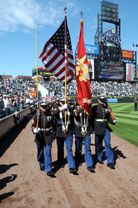 The Recruiting Station Denver Color Guard marches onto Coors Field in Denver, April 1.   Marines from RS Denver were invited to participate in the Colorado Rockies’ opening day ceremony along with members from the other armed services.