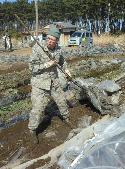 MISAWA AIR BASE, Japan – Have you done it?  Maj. Christopher Schumann from Misawa AB “did it” by helping local farmers at two strawberry farms in Hachinohe March 28.  The fields contained greenhouses to protect the crops from the harsh winter environment and were flattened by the tsunami March 11.  Major Schumann removed pipe and plastic from the strawberry field and stacked it for trucks to pick up for recycling.  He was one of 144 Airmen from Misawa AB who attended this workday, which proved to be the highest number to date since the “Misawa Helps” volunteer effort kicked off.  (U.S. Air Force photo by Bruce Bender/Released)