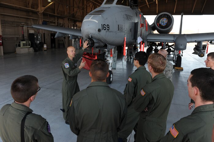 NELLIS AIR FORCE BASE, Nev. -- Maj. Marty Garrett, 57th Operations Support Squadron director of operations, explains the mechanics of a GAU-8/A Avenger gatling gun on an A-10 Thunderbolt II to U.S. Air Force Academy cadets, April 1. The purpose of this visit was to motivate cadets to pursue a career in the Air Force by exposing them to the many ways Nellis Airmen support the war effort.(U.S. Air Force photo by Senior Airman Brett Clashman)