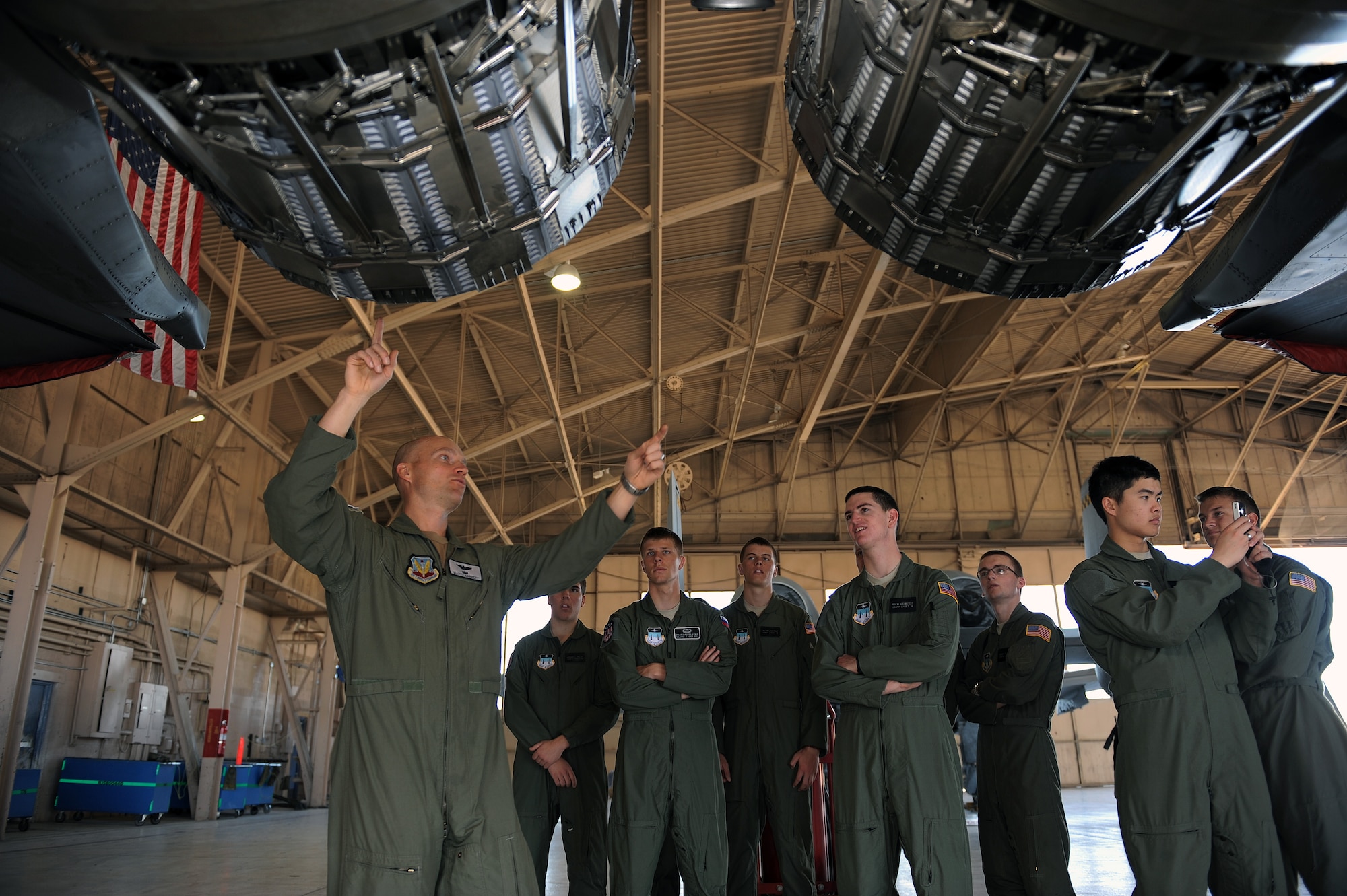 NELLIS AIR FORCE BASE, Nev. -- Maj. Marty Garrett, 57th Operations Support Squadron director of operations, talks to U.S. Air Force Academy cadets about the engine exhausts of a F-15E Strike Eagle, April 1. The purpose of this visit was to motivate cadets to pursue a career in the Air Force by exposing them to the many ways Nellis Airmen support the war effort.(U.S. Air Force photo by Senior Airman Brett Clashman)