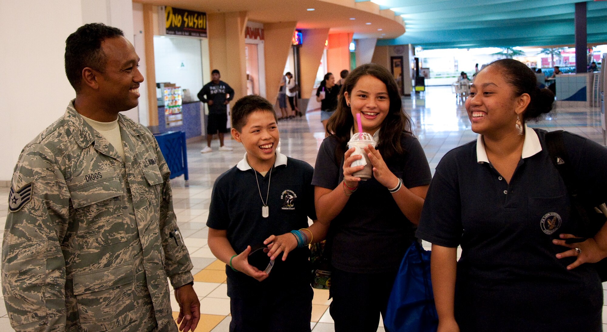 Staff Sgt. Glenn Diggs, 44th Aerial Port Squadron, talks to local teens at the informational and drug demand reduction display at the Guam Micronesia Mall, March 24-25. The display, set up by members of the 44th Aerial Port Squadron and 724th Aeromedical Staging Flight, was part of the 30th Anniversary celebration and Month of the Air Force Reserve on Guam. (U.S. Air Force Photo/Staff Sgt. Erin Smith)
