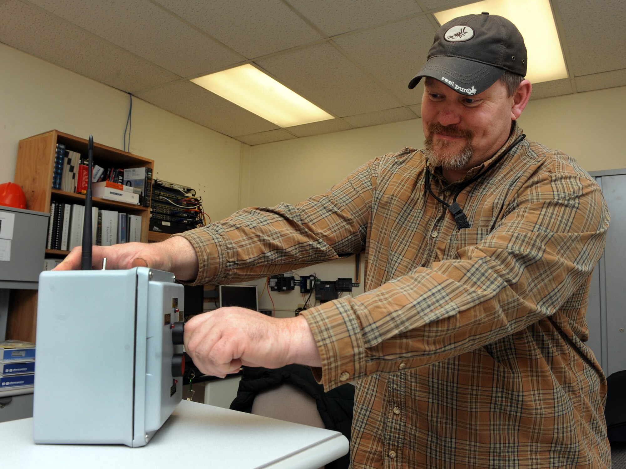 MOUNTAIN HOME AIR FORCE BASE, Idaho -- Joe Fuller, 366th Civil Engineer Squadron engineering technician, displays a $23,000 tool he created that expedites the base’s refueling capability by sending radio signals to the hotpit refueling conduit, bypassing the corroded wires that have been in place since the 1960s. Mr. Fuller's creation earned him $10,000 and saved the Air Force $1.1 million after he submitted his idea to the Innovative Development through Employee Awareness program. (U.S. Air Force photo by Senior Airman Debbie Lockhart)