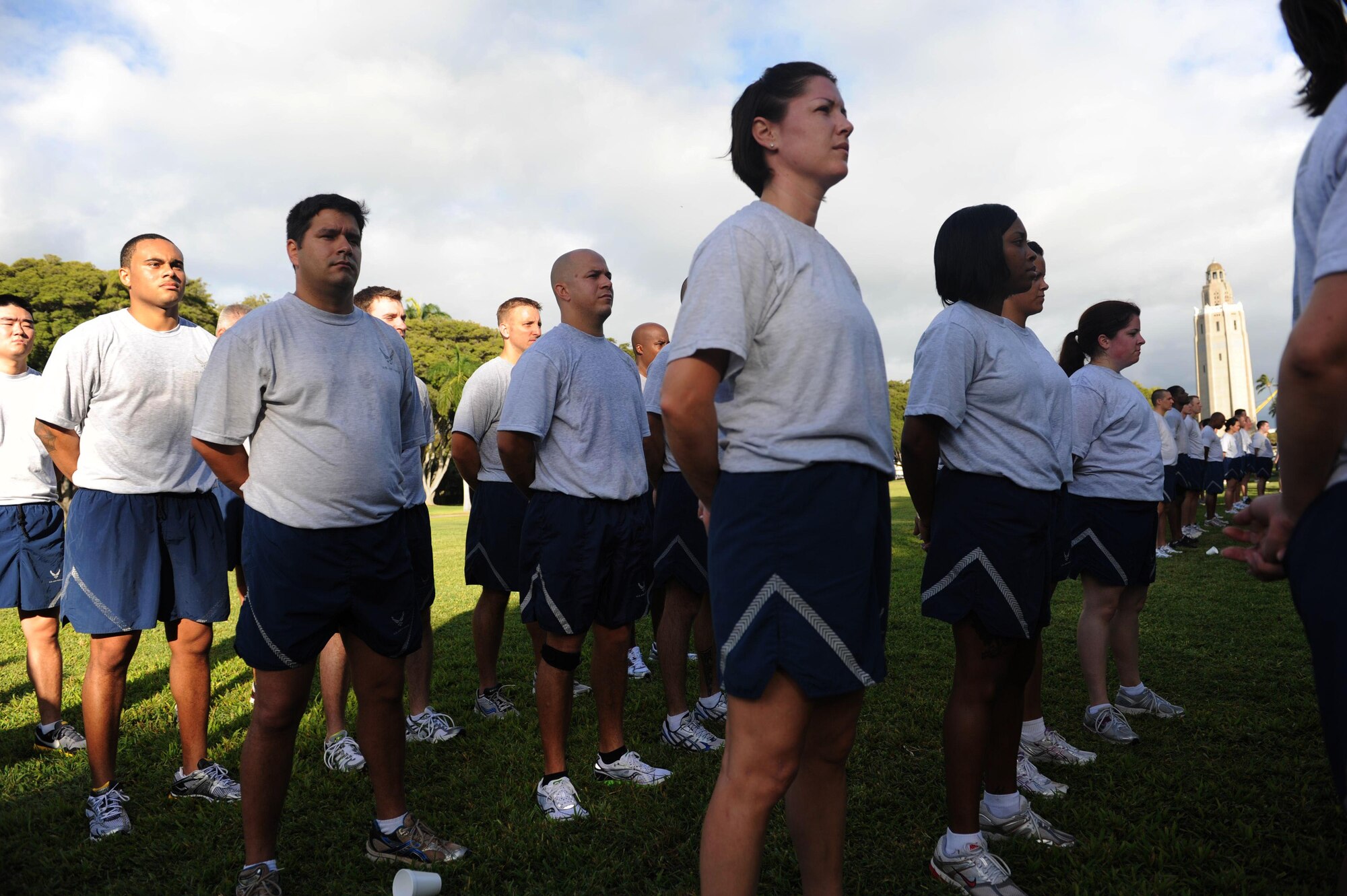 Airmen from Joint Base Pearl Harbor-Hickam, Hawaii, stand in formation after completing the monthly "Warrior Run" Apr. 1 which begins and ends at Hickam Mall. The run, which spans approximately two miles, was hosted this month by the 15th Medical Group. (U.S. Air Force photo by Staff Sgt. Nathan Allen)