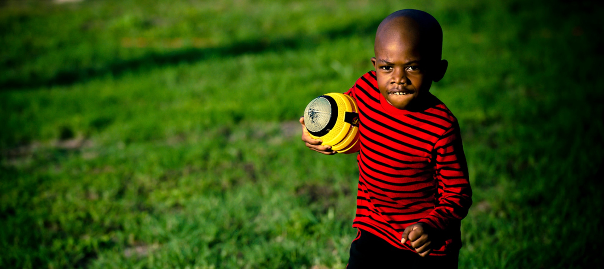 ?Uncle Face? ? or Staff Sgt. Aron Lee ? plays football with Nathaniel in the back yard. Lee got a humanitarian assignment to Lackland AFB, Texas, to help his parents raise Nathaniel after the tragic deaths of the boy?s mom and dad.
(Photo by TSgt Samuel Bendet)