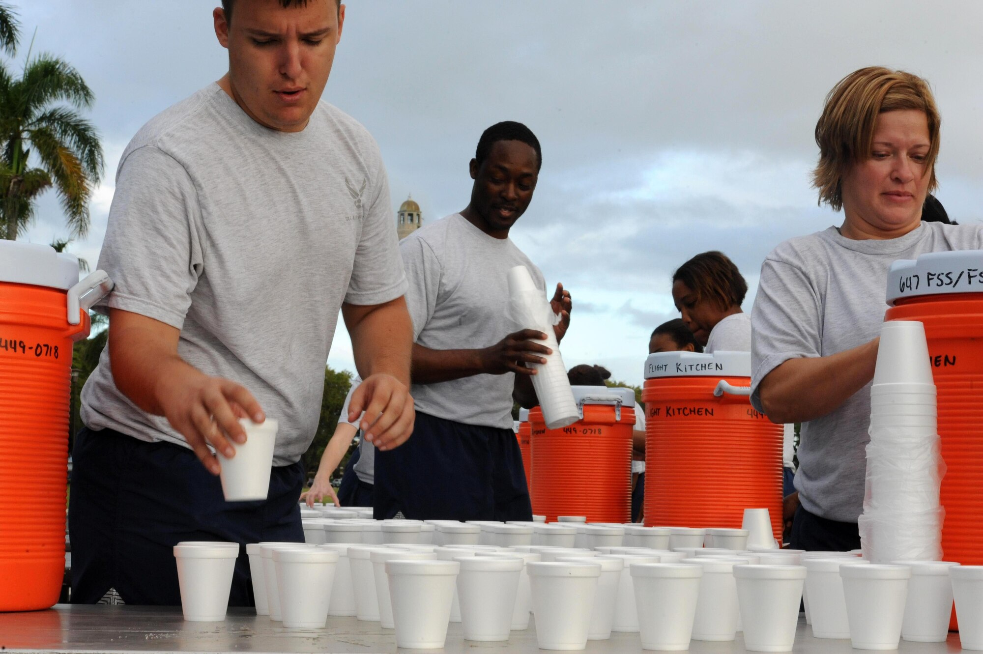 Airmen from the 15th Medical Group prepare water for participants of the monthly "Warrior Run" Apr. 1 which begins and ends at Hickam Mall. The run, which spans approximately two miles, was hosted this month by the 15th MDG. (U.S. Air Force photo by Staff Sgt. Nathan Allen)