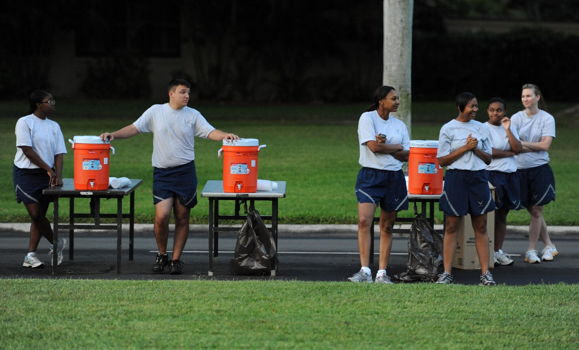 Airmen from the 15th Medical Group prepare water for participants of the monthly "Warrior Run" Apr. 1 which begins and ends at Hickam Mall. The run, which spans approximately two miles, was hosted this month by the 15th MDG. (U.S. Air Force photo by Staff Sgt. Nathan Allen)