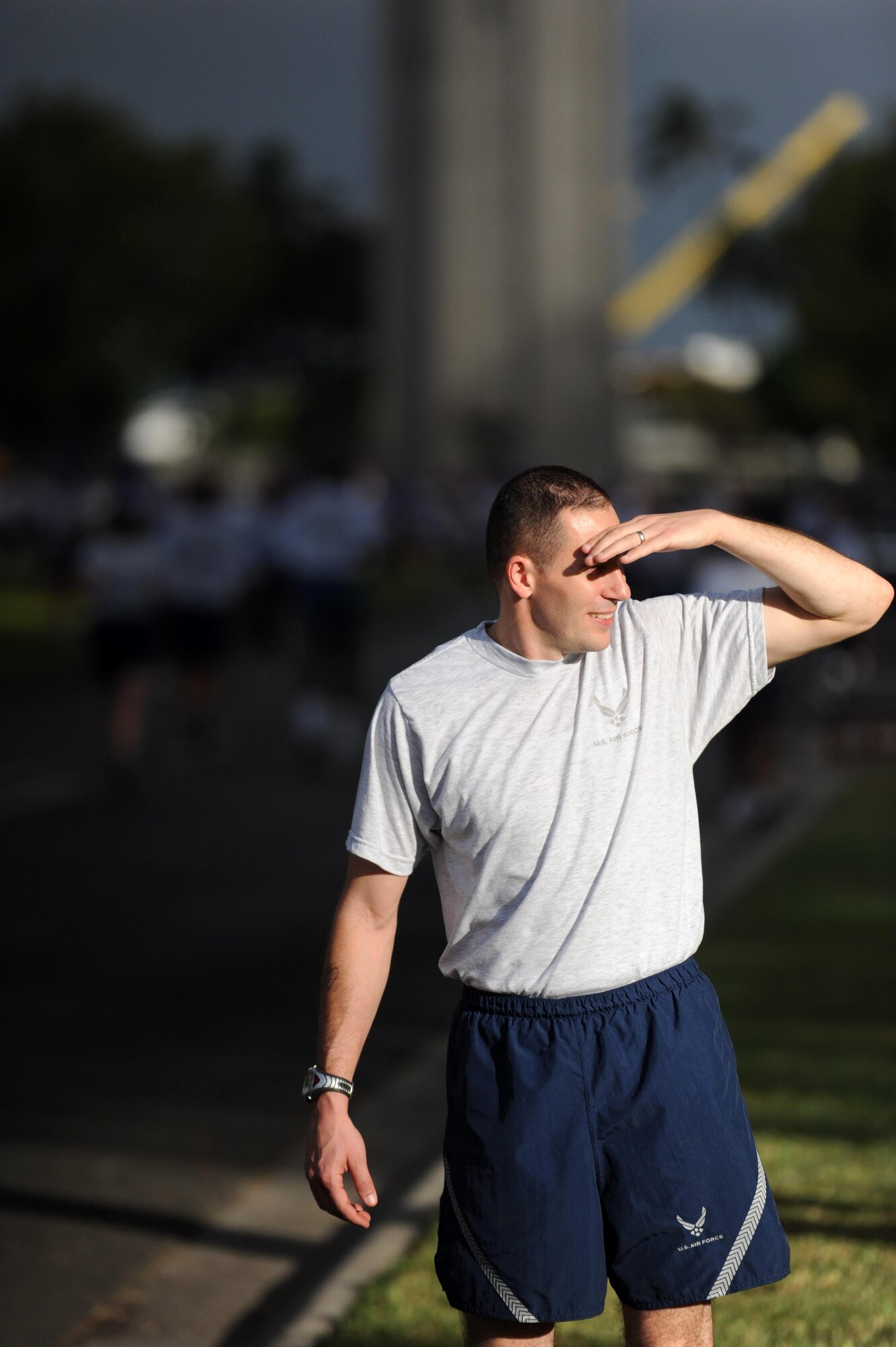 Tech. Sgt. James Kruis, a 15th Medical Group medical technician, looks for Airmen to direct and encourage as they finish the monthly "Warrior Run" Apr. 1 which begins and ends at Hickam Mall. The run, which spans approximately two miles, was hosted this month by the 15th Medical Group. (U.S. Air Force photo by Staff Sgt. Nathan Allen)