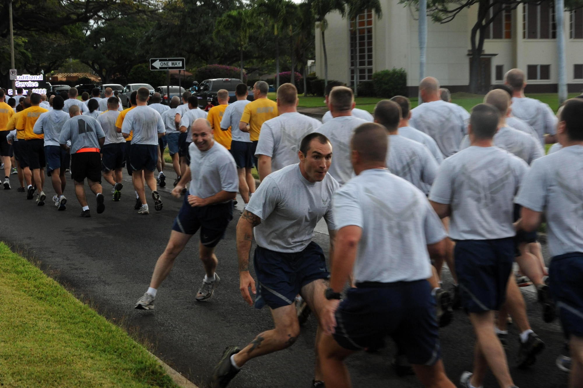 Two Airmen from Joint Base Pearl Harbor-Hickam, Hawaii, chase each other during the monthly "Warrior Run" Apr. 1 which begins and ends at Hickam Mall. The run, which spans approximately two miles, was hosted this month by the 15th Medical Group. (U.S. Air Force photo by Staff Sgt. Nathan Allen)