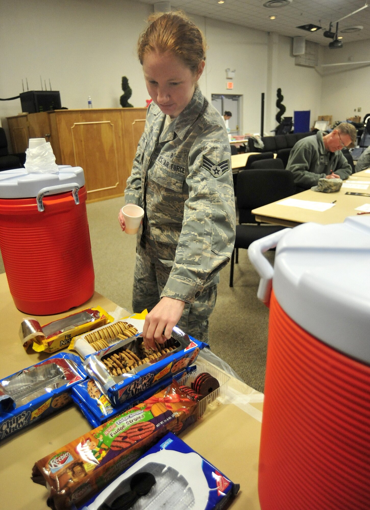 Senior Airman Peggy Schnack, 62nd Medical Squadron, grabs a few cookies from the snack center after donating blood an Armed Services Blood Bank Center blood drive March 30 at Joint Base Lewis-McChord, Wash. (U.S. Air Force photo/Airman 1st Class Leah Young)