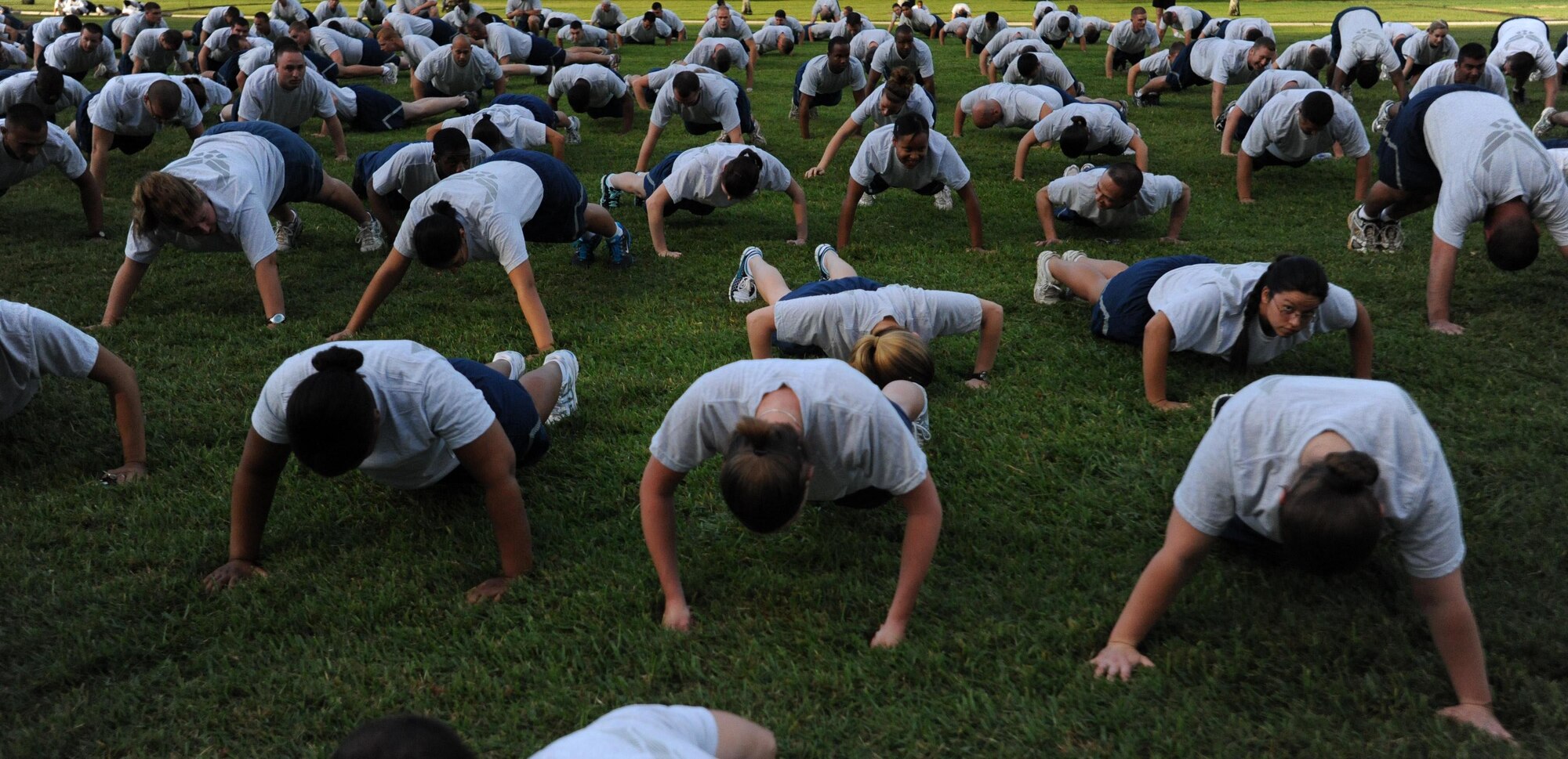 Airmen from Joint Base Pearl Harbor-Hickam, Hawaii, perform push-ups before the monthly "Warrior Run" Apr. 1 which begins and ends at Hickam Mall. The run, which spans approximately two miles, was hosted this month by the 15th Medical Group. (U.S. Air Force photo by Staff Sgt. Nathan Allen)
