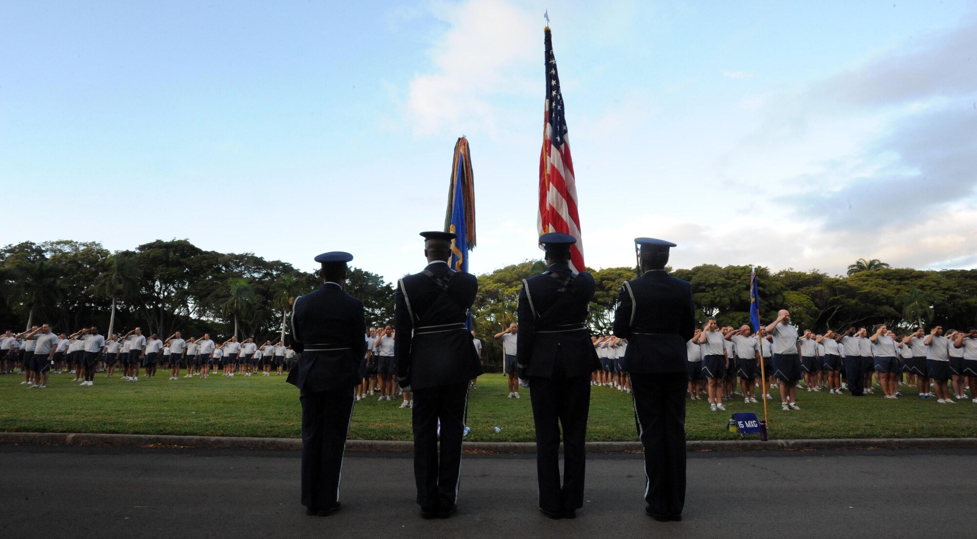 The Joint Base Pearl Harbor-Hickam, Hawaii, honor guard presents the colors before the monthly "Warrior Run" Apr. 1 which begins and ends at Hickam Mall. The run, which spans approximately two miles, was hosted this month by the 15th Medical Group. (U.S. Air Force photo by Staff Sgt. Nathan Allen)