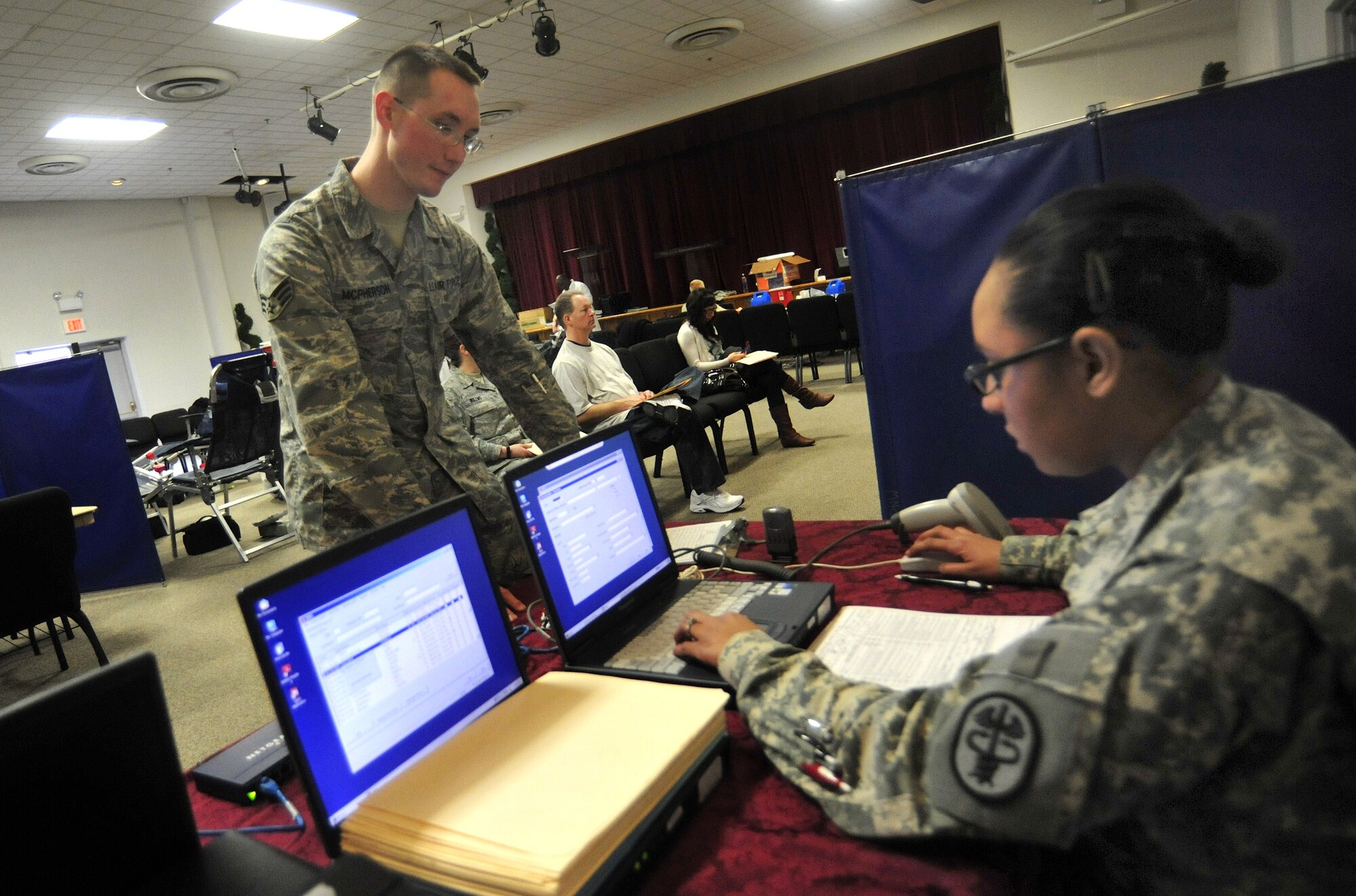 Senior Airman Ross McPherson, left, 62nd Maintenance Operation Squadron, registers for the Armed Services Blood Bank Center blood drive with the help of Specialist Vanessa Houston, ASBBC at Madigan Healthcare Facility, March 30 at Joint Base Lewis-McChord, Wash. (U.S. Air Force photo/Airman 1st Class Leah Young)