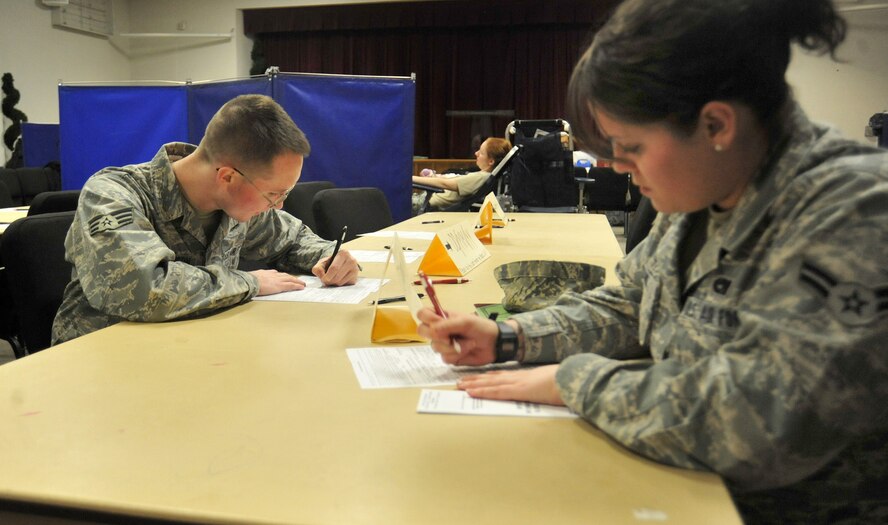 Senior Airman Ross McPherson, left,  and Airman 1st Class Renee Willms, both 62nd Maintenance Operation Squadron, fill out general information forms before donating blood during an Armed Services Blood Bank Center blood drive March 30 at Joint Base Lewis-McChord, Wash. (U.S. Air Force photo/Airman 1st Class Leah Young)
