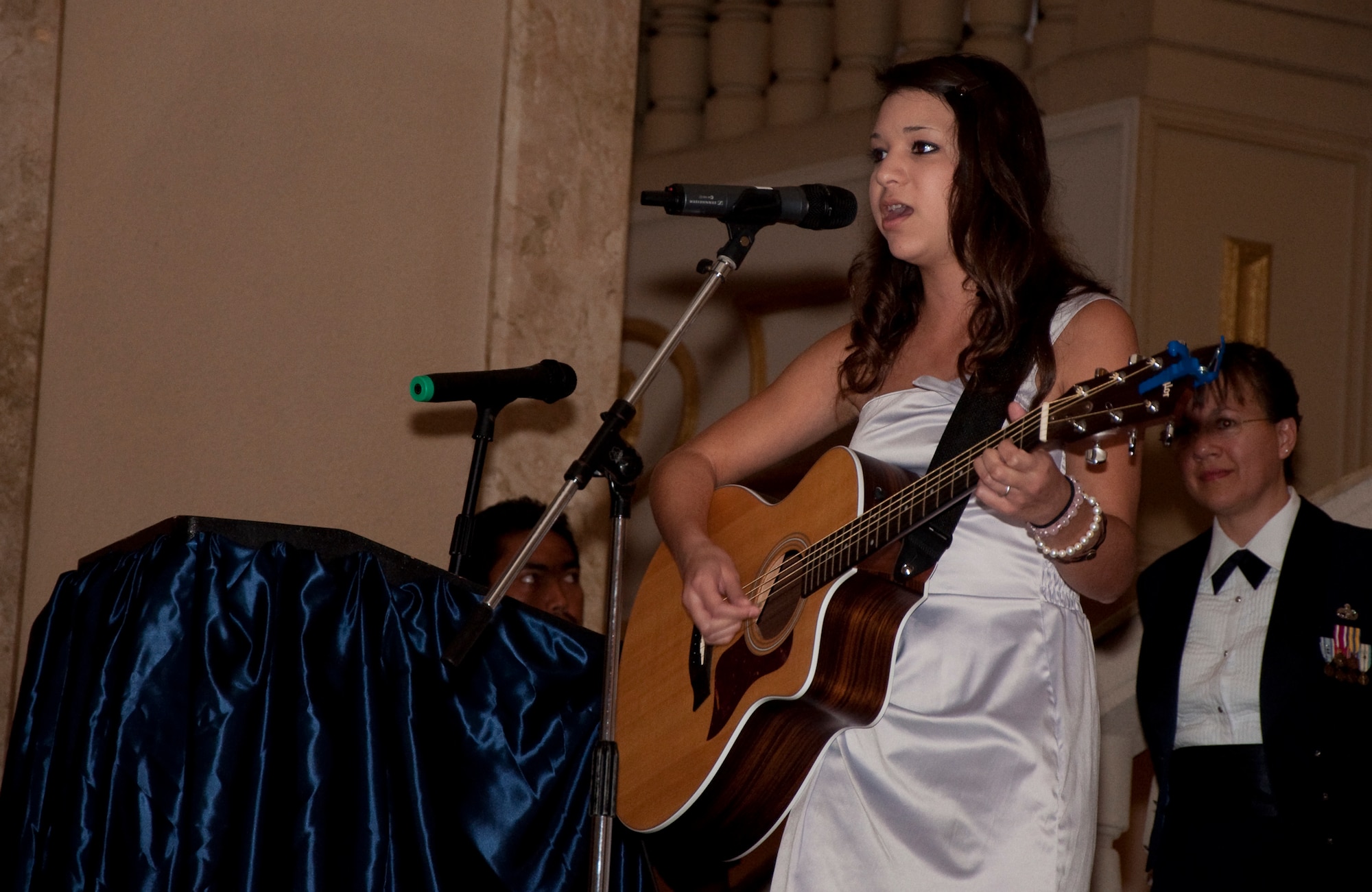 Maryssa Bland, 16, daughter of Tech. Sgt. Daniel Bland, 44th Aerial Port Squadron and Master Sgt. Judy Bland, 36th Wing Judge Advocate office, sings "Heroes," a song she wrote for her mom and dad during her mom's deployment. (U.S. Air Force Photo/Staff Sgt. Erin Smith)