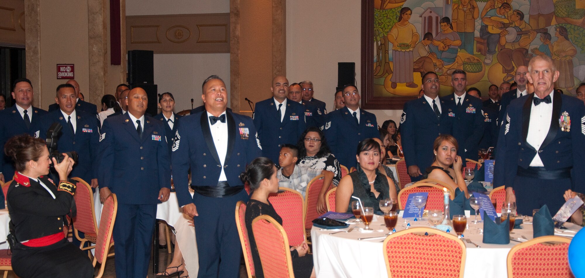 Members of the 44th Aerial Port Squadron stand to be recognized at the 30th Anniversary Banquet. More than 400 Airmen and their families were present at the event, March 26, at the Holiday Resort and Spa, Tumon, Guam. (U.S. Air Force Photo/Staff Sgt. Erin Smith)