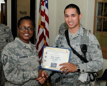 Senior Airman Jesse Angulo assigned to the 902 Security Forces Squadron, receives the Professional Performance Award from Master Sgt Terri Harmon, Randolph AFB Career Advisor on April 1 at Randolph Air Force Base. 
(U.S. Air Force Photo By Don Lindsey)