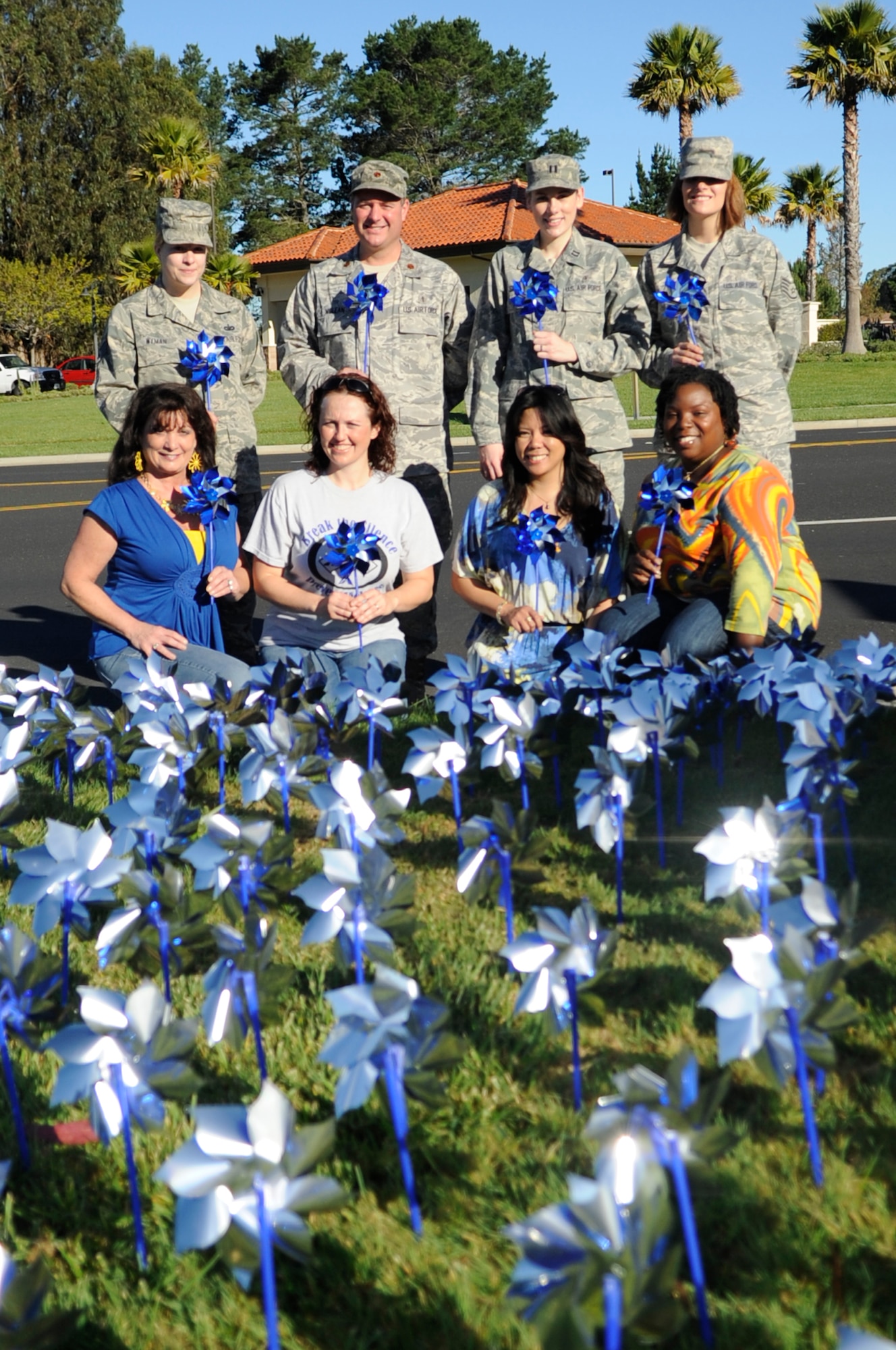 VANDENBERG AIR FORCE BASE, Calif. – Members of the 30th Medical Operations Squadron, who orchestrated the pinwheel garden for Child Abuse Awareness Month, pose for a photo at the main gate here Friday, April 1, 2011. The pinwheel garden is meant to visually remind people of the very real threat and need for child abuse prevention. (U.S. Air Force photo/Senior Airman Lael Huss)