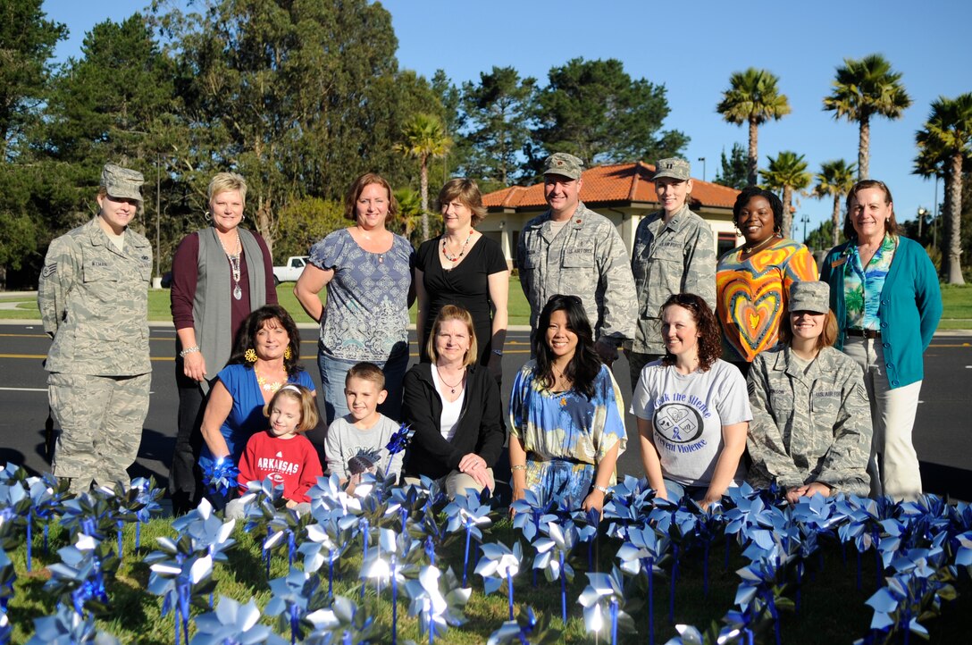 VANDENBERG AIR FORCE BASE, Calif. – Volunteers supporting Child Abuse Awareness Month pose for a photo after placing 576 pinwheels into the ground at the main gate here Friday, April 1, 2011. The pinwheel garden is meant to visually remind people of the very real threat and need for child abuse prevention. (U.S. Air Force photo/Senior Airman Lael Huss)