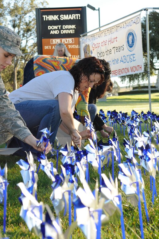 VANDENBERG AIR FORCE BASE, Calif. – Colleen Iungerman, of the 30th Medical Operations Squadron, places pinwheels into the ground outside the main gate here Friday, April 1, 2011. The pinwheel garden is a reminder of Child Abuse Awareness Month. (U.S. Air Force photo/Senior Airman Lael Huss)