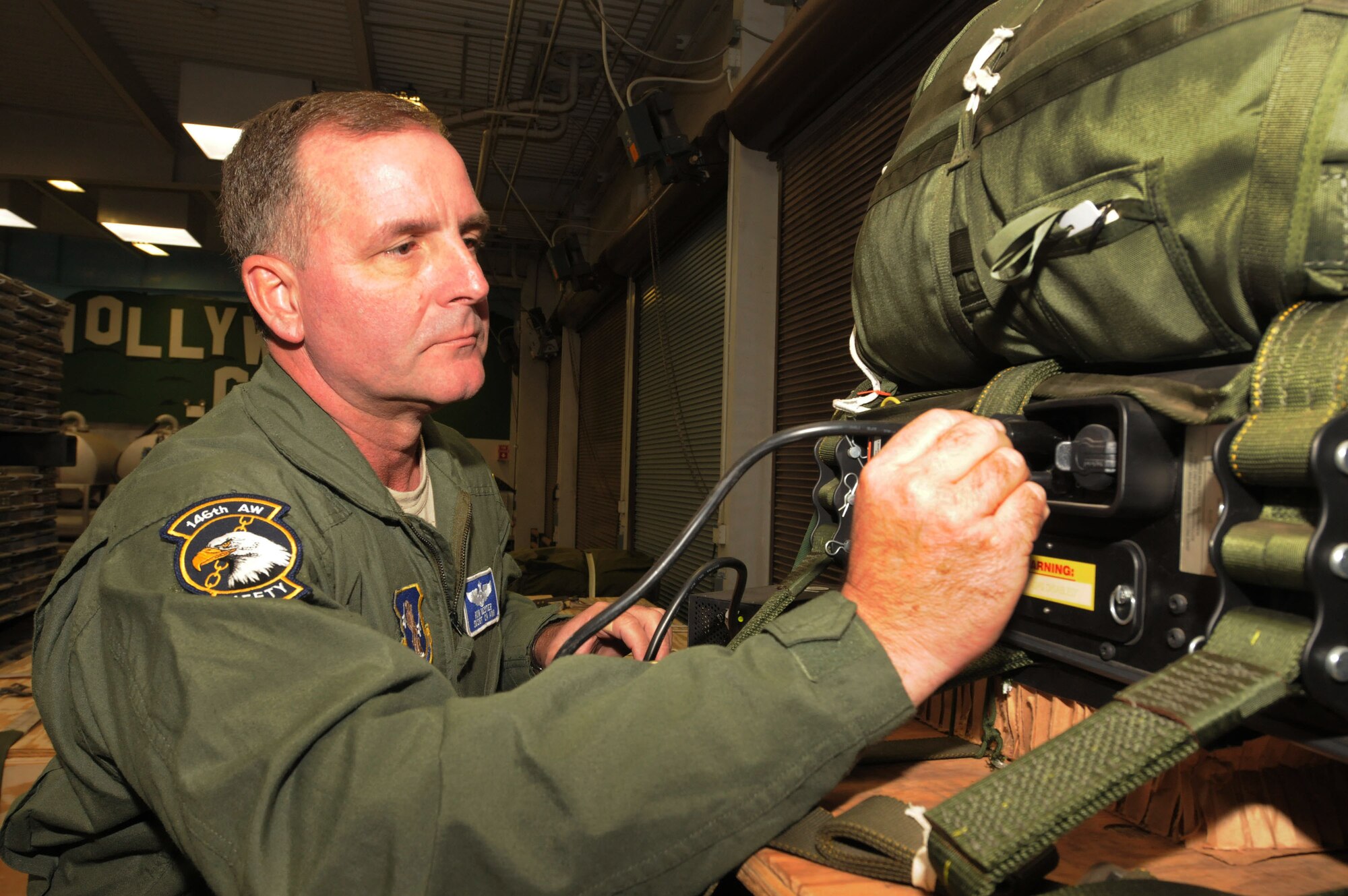 Senior Master Sgt Ron Nester, loadmaster for the 115th Airlift Sqadron, completes a pre-flight check of a C-130J at the Channel Islands ANGS. Sergeant Nester is the 2010 Outstanding Senior NCO of the Year.